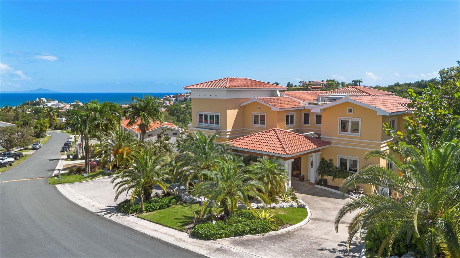 One or more photo(s) has been virtually staged. One or more photos have been virtually staged. Experience elevated coastal living in the heart of Palmas del Mar, where luxury, space, and breathtaking ocean and marina views converge. This exceptional residence offers over 5,380 interior square feet and has been meticulously renovated to high-end standards, delivering a truly move-in-ready lifestyle in one of Puerto Rico’s most sought-after resort communities.

Designed for both refined daily living and effortless entertaining, the home features five generously sized bedrooms plus a dedicated office, including a first-floor bedroom and full bath—ideal for guests or multigenerational living. Expansive living areas are filled with natural light, while large windows frame sweeping ocean sunrises and unforgettable marina sunsets.

At the center of the home, the fully renovated chef’s kitchen blends style and functionality, flowing seamlessly into open living and dining spaces. A private movie theater offers the perfect setting for relaxed evenings or entertaining at home.

Thoughtful upgrades include solar panels, a 20k diesel generator, and quality finishes throughout, enhancing both comfort and long-term efficiency. Outdoor spaces invite year-round enjoyment, complete with a fire pit ideal for evening gatherings.

Located within Palmas del Mar, residents enjoy access to championship golf courses, marinas, beaches, dining, shopping, and resort-style amenities, all within a secure, master-planned community.

Additional Highlights:
Over 5,380 interior sq ft
5 bedrooms + office
Private movie theater
Renovated kitchen
Ocean and marina views
Solar panels + 20k diesel generator
Fire pit
Garage plus driveway parking for up to 6 vehicles
HOA: $1,300/year
CRIM: $4,818/year

This is a rare opportunity to acquire a fully renovated luxury residence offering exceptional value, scale, and lifestyle in Palmas del Mar.