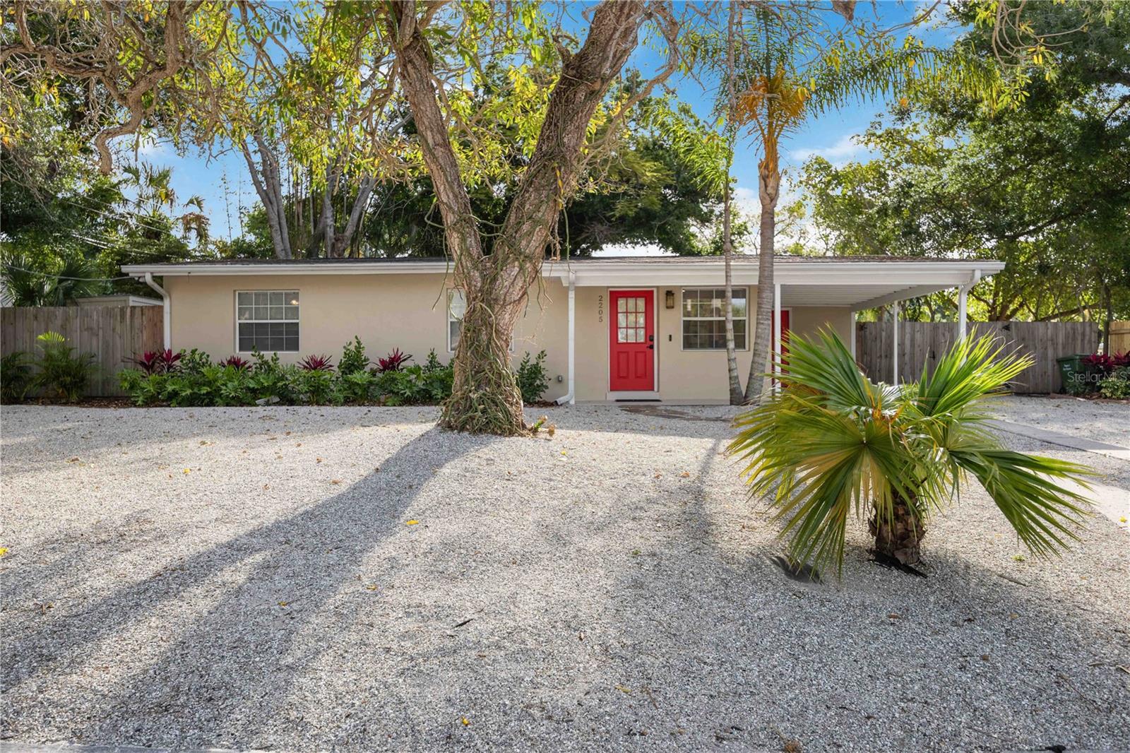 Welcome to this beautifully reimagined residence in the highly sought-after Arlington Park neighborhood, where modern updates meet a peaceful, tucked-away setting. Completely renovated from top to bottom in December 2023, this home showcases meticulous attention to detail throughout. Perfectly positioned on a corner lot along a quiet dead-end street, the home enjoys a unique sense of privacy, with mature trees, lush landscaping, and a shaded backdrop that enhances the serene setting. Enter through the front door into a light-filled interior, where thoughtful design and quality craftsmanship are immediately apparent. Rich hickory hardwood flooring flows throughout, complemented by a fresh, neutral palette, updated trim, and refined finishes that create a cohesive and inviting atmosphere. The main living space unfolds with effortless flow, offering a bright and welcoming environment ideal for both everyday living and entertaining. The large dining/breakfast area features sliding glass doors which draw the eye outward and open to a newer constructed deck, seamlessly blending indoor and outdoor living. The updated kitchen is both stylish and functional, featuring solid wood cabinetry, sleek quartz countertops, updated stainless appliances, and a tasteful backsplash, creating a space that is as practical as it is visually appealing. The primary bedroom offers a comfortable retreat, while the bathrooms have been completely transformed with designer selections. The main bath showcases a double vanity, elegant finishes, and a beautiful Kohler cast iron tub paired with Moen fixtures. The guest bath features a new glass shower enclosure, continuing the home’s elevated aesthetic. 2 additional bedrooms provide flexibility for family, guests, or a home office, each thoughtfully finished with updated flooring, lighting, and fixtures. A brand-new front-load LG washer and dryer adds everyday convenience. Step outside to a private, fenced backyard framed by mature areca palms and low-maintenance rock landscaping, creating a tranquil outdoor setting. A double-gated fence offers valuable space for storing a boat or small RV, while the newly coated carport enhances both function and presentation. Improvements in 2023 include all new electrical wiring brought up to current Florida Building Code, new water supply lines, replacement of cast iron drain lines with PVC, new insulation and drywall including ceilings, updated lighting and fixtures, a new HVAC system, water heater, and fresh exterior paint—delivering peace of mind and true move-in readiness. Ideally located just moments from Arlington Park’s walking trails, dog park, and recreational amenities, and only minutes to Sarasota Memorial Hospital, downtown Sarasota, and the world-renowned beaches of Siesta Key and Lido Key, this residence offers an exceptional combination of location, lifestyle, and investment potential with flexible minimum lease options. Schedule your showing today!