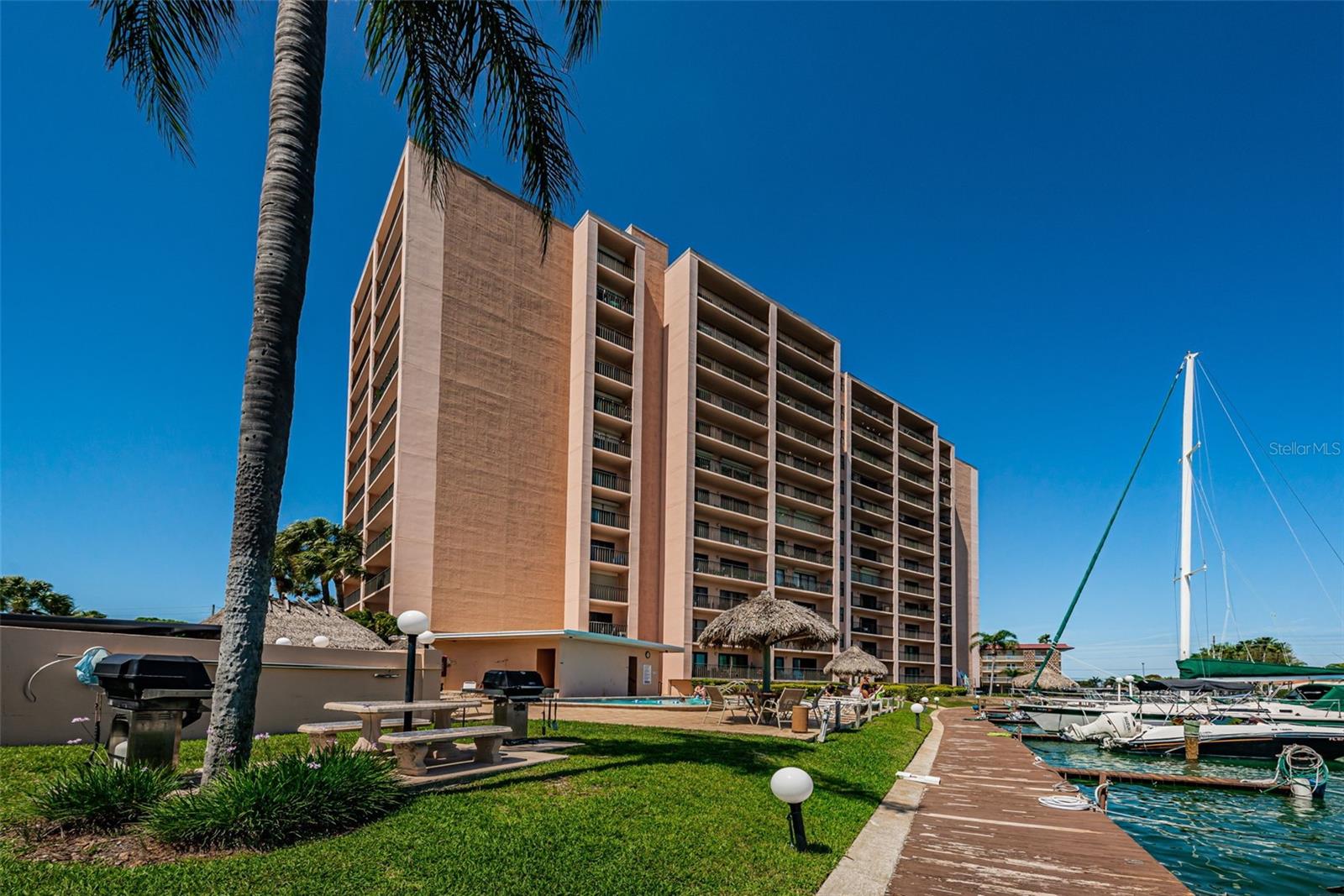Enjoy the Florida Lifestyle!  Live in a waterfront community with resort like amenities and feel like you are on vacation every day. Oversized one bedroom unit has perfect panoramic views of the Intracoastal from every room.  The main living room is updated with luxury vinyl flooring,  a large mirror that reflects the view and sliders to the balcony. Wake up to the sunrise from the king sized bedroom with balcony access and walk in closet.  Updates include water heater 2025, electric panel 2021, interior paint, upgraded interior doors, mirror in living room, decorative wood wall in the entrance and a nook for charging and storage.  The 51 Island Way building has a newly renovated lobby with keyless entry and a manager onsite. Enjoy the waterside heated pool and spa, tennis and shuffleboard. Relax and take in the view from several Tiki huts or the grill/picnic area.  If you are a boater, the deep water dock slips are available.   Location! Island Estates is a prime location for enjoying the coastal lifestyle.  The white sands of famous Clearwater Beach are minutes away along with restaurants, shopping and activities.  There are fishing boat charters, pirate ship, parasailing and more. The Jolley Trolley is perfect for getting there and back.  Groceries, banking and restaurants are also with-in walking distance.    Enjoy all Tampa Bay has to offer!  A short drive will take you to all renowned Pinellas beaches, sporting events, attractions and the Tampa Bay International Airport.  Investors – Renter is in place if needed!   Be sure and watch the video for more photos.