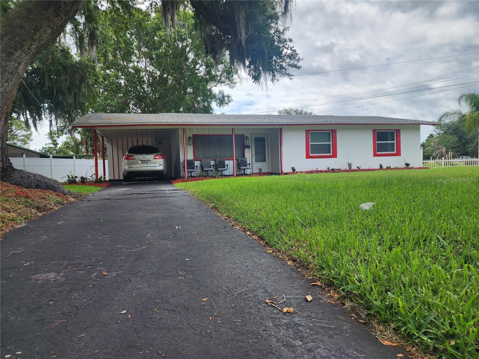 Largest lot in the community and ideally located just minutes Fiske Blvd, I-95 and US-1. This spacious corner lot is fully fenced with charming white picket fencing, mature shade trees, and lush St. Augustine grass, creating a beautiful outdoor setting. Inside, the home has been thoughtfully updated with an open-concept layout designed for comfortable living and entertaining. A large triple front window fills the space with natural light, making the home feel bright and inviting. There are 2 generously sized guest beds and hall bath. The primary suite overlooks the backyard and features a private en suite bath. A versatile bonus/flex space offers can be used as a game room, playroom, home office, or den. Additional features include a spacious utility room/workshop located off the carport. The carport also offers the potential for easy converted into a garage. Roof replaced in 2025, HVAC and hot water heater 2018.