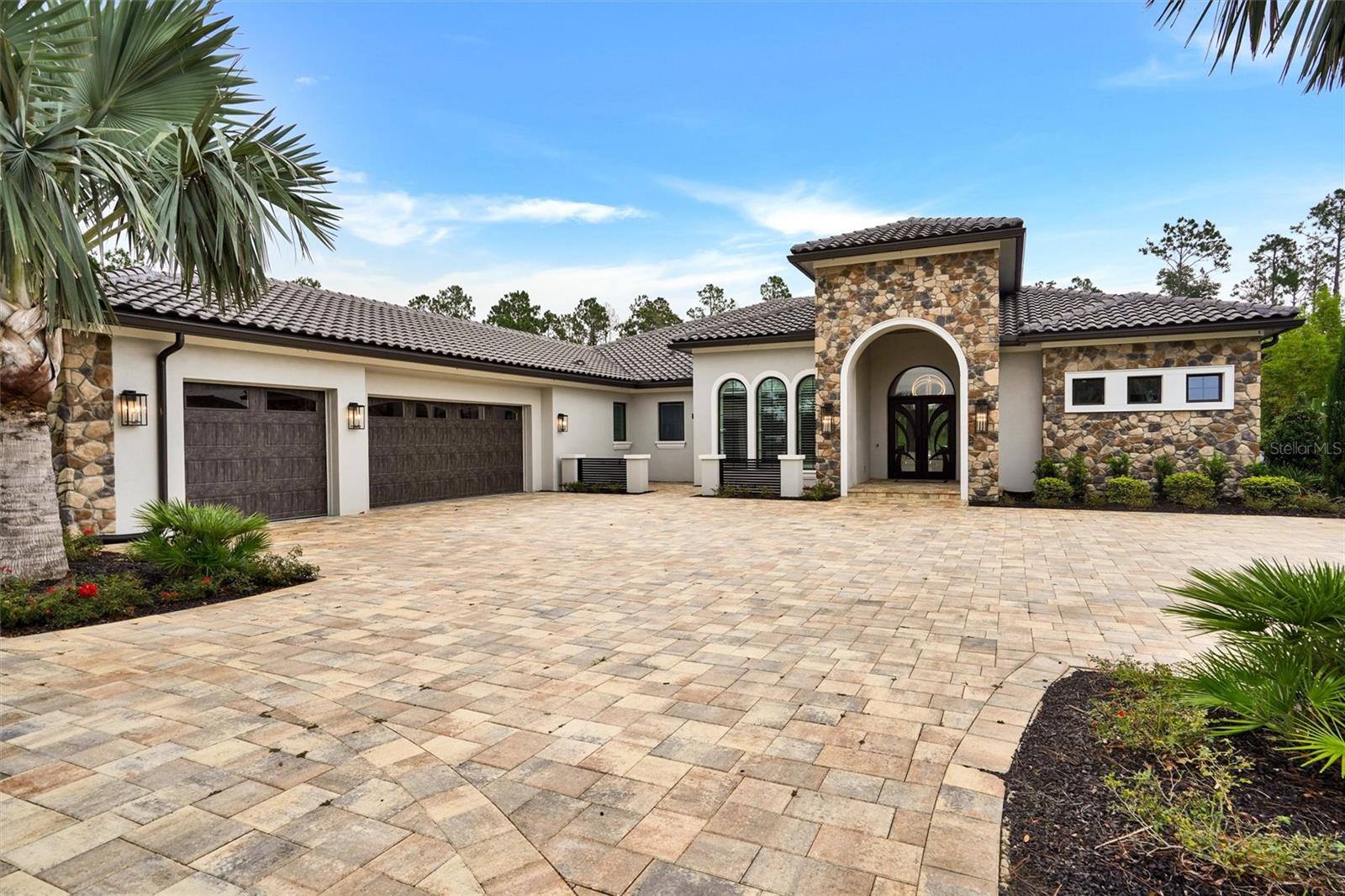 Experience the Pinnacle of Luxury Living in Bella Collina

Welcome to a one-of-a-kind luxury estate nestled on an oversized, meticulously landscaped lot in the luxurious, guard-gated community of Bella Collina—Central Florida’s premier golf and lifestyle destination.

This stunning 5-bedroom, 5-bath modern masterpiece offers the perfect blend of sophistication, comfort, and innovation. From the moment you arrive, you’ll be captivated by the breathtaking curb appeal, highlighted by an expansive paver-stone driveway and a 3-car garage with mini-split A/C for added convenience.

Inside, designer features abound—porcelain floors throughout, motorized shades, and full smart home technology for lighting, climate, audio, video and security.

The expansive great room is the heart of the home, designed for both everyday living and elegant entertaining. It boasts a 100-inch TV, a sleek electric fireplace mounted on a granite accent wall, and soaring ceilings that create a sense of warmth and grandeur.

The chef’s kitchen is a culinary dream, equipped with a Sub-Zero refrigerator/freezer, Wolf 6-burner gas range, GE Monogram double ovens, a Sharp microwave oven, matching granite with the great room and custom cabinetry with premium finishes.

Step outside to the resort-style lanai, thoughtfully divided into three distinct areas:

A relaxation zone with a gas fireplace and 100-inch TV mounted on a stone accent wall.
A versatile dining or gathering area adaptable to your needs.
A summer kitchen with grill, sink, refrigerator, and bar seating.
The over 1500 square foot covered lanai is enclosed with retractable screens that open to reveal the stunning pool with waterfalls, fire features, spa, dry seating conversation pit and a covered cabana complete with ceiling fans and a comfortable lounging area.

Retreat to the luxurious primary suite, which features its own large-screen TV, a beautiful electric fireplace, dual walk in closets and finishes that feel straight out of a high-end resort including built in mini fridge, sink and a spa inspired bathroom with soaker tub, an oversized walk in shower with built-in benches and multiple shower heads.

One of the bedrooms could serve as a secondary primary suite, designed with corner sliding doors that fully retract, offering immediate access to and views of the stunning lanai, pool, and gardens.

Additional features include:
A private in-law suite with exterior entrance, kitchenette, walk-in closet, full bath, and screened-in covered porch.
A dedicated office with custom built-ins
Spacious guest bedrooms and elegantly appointed ensuite bathrooms throughout.

Living in Bella Collina means enjoying world-class amenities including 24-hour gated security, a Nick Faldo–designed championship golf course, luxury spa, tennis, fitness center, and a picturesque Tuscan-style clubhouse.

This is more than just a home—it’s a lifestyle.

This home has far too many exquisite features to list.  This home must be viewed in person to be fully appreciated.  Schedule your private showing today and see why this extraordinary property stands in a class of its own.