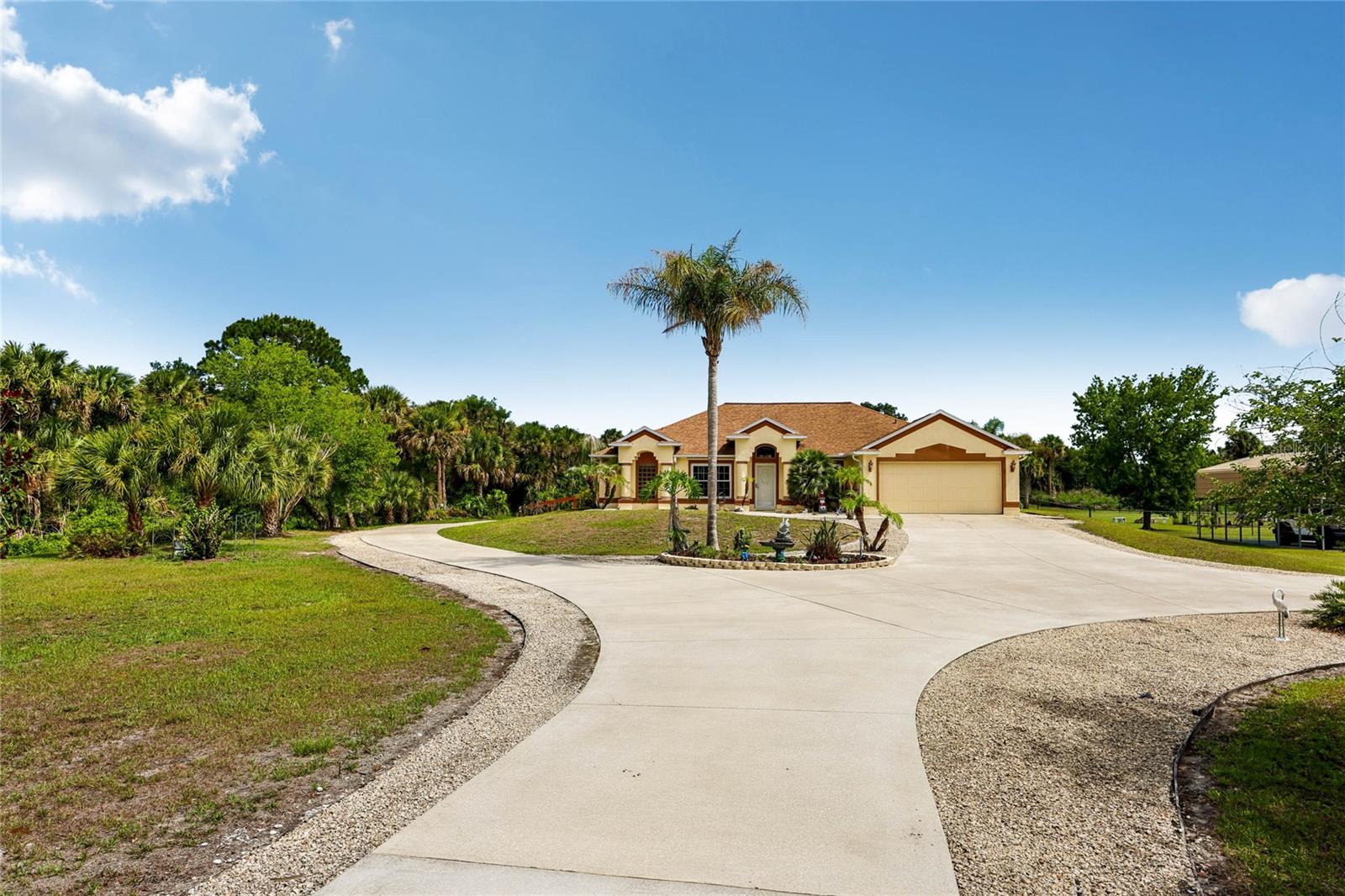 Nestled on 3.67 acres in Canaveral Groves, this exceptional estate offers the perfect blend of privacy, space, security, and modern upgrades while remaining conveniently close to shopping, dining, beaches, and major roadways. Only 20 – 30 minutes to the beach and to the Cape Canaveral Space Station, you can view spectacular rocket launches from your backyard.
As you enter through the large electric iron security gate, you're welcomed by expansive, beautifully manicured grounds featuring lush, level acreage and a long concrete driveway with parking for more than 10 vehicles for home events. The property also includes a separate covered RV port complete with 30/50-amp electrical service and water hookups, making it ideal for RV owners, guests, or extended stays.
This meticulously maintained 4-bedroom, 2-bathroom home features a bright open-concept design with vaulted ceilings and spacious living and family rooms, creating the perfect environment for both everyday living and entertaining. The beautiful kitchen serves as the heart of the home, showcasing stone countertops, major appliances, and ample space for cooking, gathering, and hosting family and friends.
The primary suite offers a private retreat with a remodeled ensuite bathroom featuring a walk-in shower and spacious walk-in closet. Additional bedrooms provide flexibility for guests, a home office, hobbies, or growing family needs.
Step outside to your own private Florida oasis. The stunning pool features a timeless design, surrounded by an expansive brick paver deck and a covered patio perfect for relaxing in the shade. The screened pool enclosure extends your outdoor living space year-round, while hurricane-rated storm panels provide additional privacy and protection during severe weather.
The 3.67-acre property offers endless possibilities for animals, recreation, gardening, equipment storage, or simply enjoying the freedom and tranquility of country living. Mature landscaping throughout the property includes palm trees, oaks, maples, creating a beautiful natural setting with exceptional privacy.
For those needing workspace or storage, the property includes multiple outbuildings. A dedicated workshop shed with electricity provides the perfect space for tools, projects, and workstations. A second shed offers covered vehicle parking along with additional storage for tools and equipment. A third storage shed provides even more space for lawn equipment, recreational gear, and seasonal items.
This rare Canaveral Groves property combines acreage, functionality, security, and resort-style outdoor living with a family-oriented neighborhood with great holiday parades locally in the neighborhood, a remarkable opportunity.