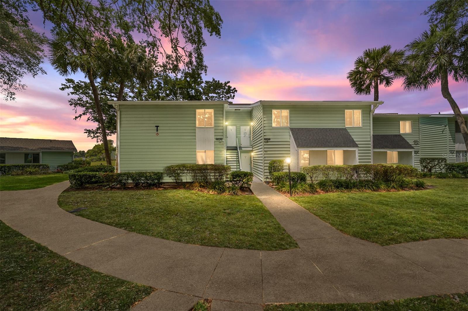 Welcome home to a two-bedroom, one-and-a-half-bath condominium in the lovely Live Oak Village, a 55-plus community in Ocala, Florida. This second-floor residence offers unobstructed views of Lake Sparkle and is a short walk to the pool and clubhouse. Brand new carpet has just been installed throughout, and the unit is furnished and ready for you to move in and enjoy. The HOA fees cover essential amenities, including basic cable, insurance, maintenance of the building and common areas, garbage pickup, and access to the community pool and clubhouse. Grocery stores, pharmacies, local restaurants, and hiking trails are all within minutes. The streets are lined with beautiful oak trees providing plenty of shade for daily walks. The grounds are well-lit at night, and this community experiences minimal traffic due to its location on a dead-end road. Ready for immediate occupancy.