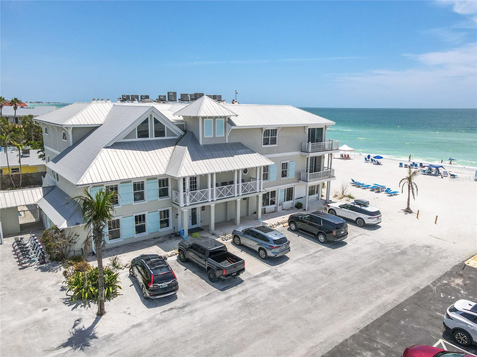 Experience the perfect blend of luxury beachfront living and strong investment potential with this rare Gulf-front condo-hotel residence on Anna Maria Island, designed in the timeless style of a charming New England coastal inn. This intimate 12-unit boutique community offers direct access to the sandy beaches of the Gulf of Mexico and delivers one of the most desirable beachfront locations in Florida. Unit #6 is ideally positioned on the second floor and accessed by both an elegant staircase and elevator, offering convenience along with privacy and elevation for enhanced views.

This spacious 2-bedroom, 2.5-bath beachfront condo features beautiful original hardwood flooring, crown molding, and a bright open layout designed for coastal comfort. A rare highlight of the residence is its two private balconies, one extending from the living room and the other from the primary suite, providing panoramic Gulf views, pool views, and unforgettable sunset skies—perfect for morning coffee, evening relaxation, or listening to waves rolling onto the shore. The interior is thoughtfully appointed with built-in closets, in-unit washer and dryer, and a fully turnkey package that includes furnishings, décor, beach equipment, kayaks, and paddleboards, allowing for immediate enjoyment without additional setup.

As part of a professionally managed condo-hotel investment property, owners benefit from up to 120 days of personal use a year while the on-site management team handles rentals the remainder of the time. With its prime beachfront location on Anna Maria Island, the property consistently achieves strong occupancy rates, making it an attractive income-producing vacation rental investment. Even better, ownership allows you to enjoy months of personal beachfront living annually while rental income helps offset operating costs, creating both lifestyle value and financial efficiency.

Offered fully turnkey, this residence checks every box for buyers seeking a luxury beachfront condo on Anna Maria Island, a Gulf-front vacation rental investment property, or a low-maintenance coastal retreat in Florida. Simply bring your swimsuit and start enjoying beachfront living at its finest—where lifestyle, location, and long-term value all come together in one exceptional opportunity.