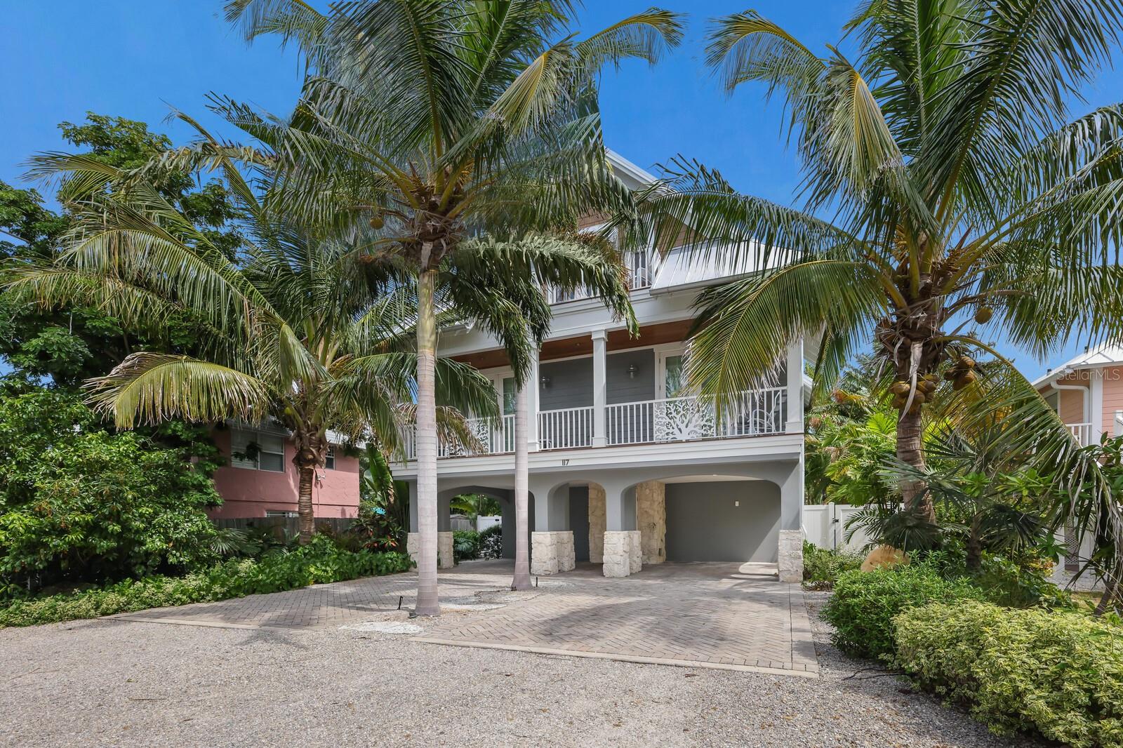 Nestled just a short stroll from the sugary white sands of the Gulf of Mexico, Coral Kai offers the quintessential coastal living experience. This almost brand new, Ross Custom Built pool home offers luxurious living space featuring high ceilings and an open-concept design that seamlessly blends the kitchen, family room, and dining space. Plank wood ceilings adorn this expansive area, creating a warm and inviting atmosphere. The kitchen is a chef's dream, featuring a large island with seating for four, quartz countertops, stainless steel appliances, soft-close cabinetry, and a full-sized butler’s pantry. The glass tile backsplash adds a touch of elegance to this modern space.

The spacious owner's ensuite is a dream retreat, with balcony access and a bathroom boasting a double vanity and a glass-enclosed tile shower. The second bedroom upstairs offers ample storage, balcony access (where the sea breeze can be your daily companion) and convenient access to the second bathroom. The third ensuite bedroom is bright and airy and comes with a spa-like bathroom that includes a walk-in shower. A delightful perk for visiting guests is the third-floor coffee bar and beverage station. You’ll marvel at the fabulous outdoor living space with an expansive covered patio, sparkling pool, sun shelf, and spa. Enjoy games and snacks in the downstairs game room. Throughout the home, 8-foot solid 5-panel doors, plank tile floors, crown molding, and recessed LED lighting exude sophistication and charm along with an elevator and washer and dryer for convenience.

This coastal haven offers access to all 7 miles of Anna Maria Island (via a free trolley) making it a true beach lover’s paradise. Coral Kai represents more than a home, it’s a lifestyle.