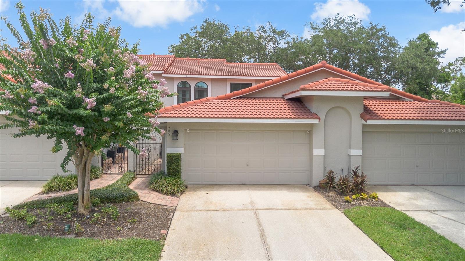 Welcome home to your completely updated townhome with brand new double pane windows throughout & private wooded views with no rear neighbors, located in the highly desirable gated Sandpointe in Dr. Phillips. As you enter through the gated brick paver courtyard you are greeted by a quaint porch that is ideal for a cookout or your private organic herb garden. A custom contemporary frosted glass inlaid front door leads you to the foyer that opens up to quite possibly one of the most tastefully decorated townhomes on the market. This open floor plan features upgraded laminate wood & ceramic tile floors throughout & is highlighted by 16' ceilings with plant shelves that are ideal for displaying your most prized artifacts. The living & dining room feature a breakfast bar that opes up to the kitchen making this the ideal location to serve your guests your facorite culinary creations. The reconfigured functional gourmet kitchen is a chef's dream come true & is equipped with LG stainless steel appliances, upgraded cabinets with soft close doors, plenty of deep drawers & spacious Quartz counter tops with tile backsplash. The adjacent nook offers serene courtyard views through the double pane sliding doors & features a Butler's pantry with a second Lazy Susan corner cabinet organizer. Your private master retreat offers serene & private wooded views & opens up to the private lanai, the ideal location to enjoy your morning coffee/tea & the perfect escape after a long day while sipping on your favorite libation to the sounds of your own private bird sanctuary. The en-suite spa inspired master bath features dual sinks Quartz vanity with upgraded Hansgrohe faucets, plenty of cabinet space & an oversized river rock walk-in shower with floor to ceiling hand cut stone walls, dual shower heads & recessed shelves. A private toilet & a spacious walk in closet that is sure to satisfy the most discriminating fashionista are adjacent. The private guest bath is next to the staircase featuring custom hand rails & under stairs storage hidden behind the shelved secret door. The 2nd floor landing features architecturally rich domed windows with plenty of natural light & leads to the 2nd & 3rd bedroom featuring an en-suite sink & bath access making it ideal as a 2nd master. The 2nd floor bathroom features a 2nd Kohler pedestal sink & tub & shower with Hansgrohe fixtures. This energy efficient turn key townhome with a new tile roof in 2021 will not last long.Sandpointe offers a club house with a kitchen, a heated community pool, fitness studio, Bocce Ball court & tennis courts. Resort style living in a gated community with the HOA taking care of the exterior & roof maintenance, all the lawn maintenance plus a termite bond for your peace of mind. Enjoy an evening stroll to Trader Joe's & The Parkside community park which are around the corner. The Marketplace is minutes away featuring a wide array of shops & restaurants including the brand new Crunch Fitness, Christini's Ristorante Italiano, a Greenwise Publix, Starbucks, Home Goods & Home Sense for your last minute shopping needs. Preview your favorite book at Barnes & Noble, or visit one of the many restaurants on the famous Restaurant Row to curb any craving you may have. Dellagio is also around the corner offering specialty restaurants such as Dragonfly Sushi & Fleming's Steakhouse. All this in quite possibly one of the best locations in SW Orlando, close to major highways, shopping malls & all the area attractions