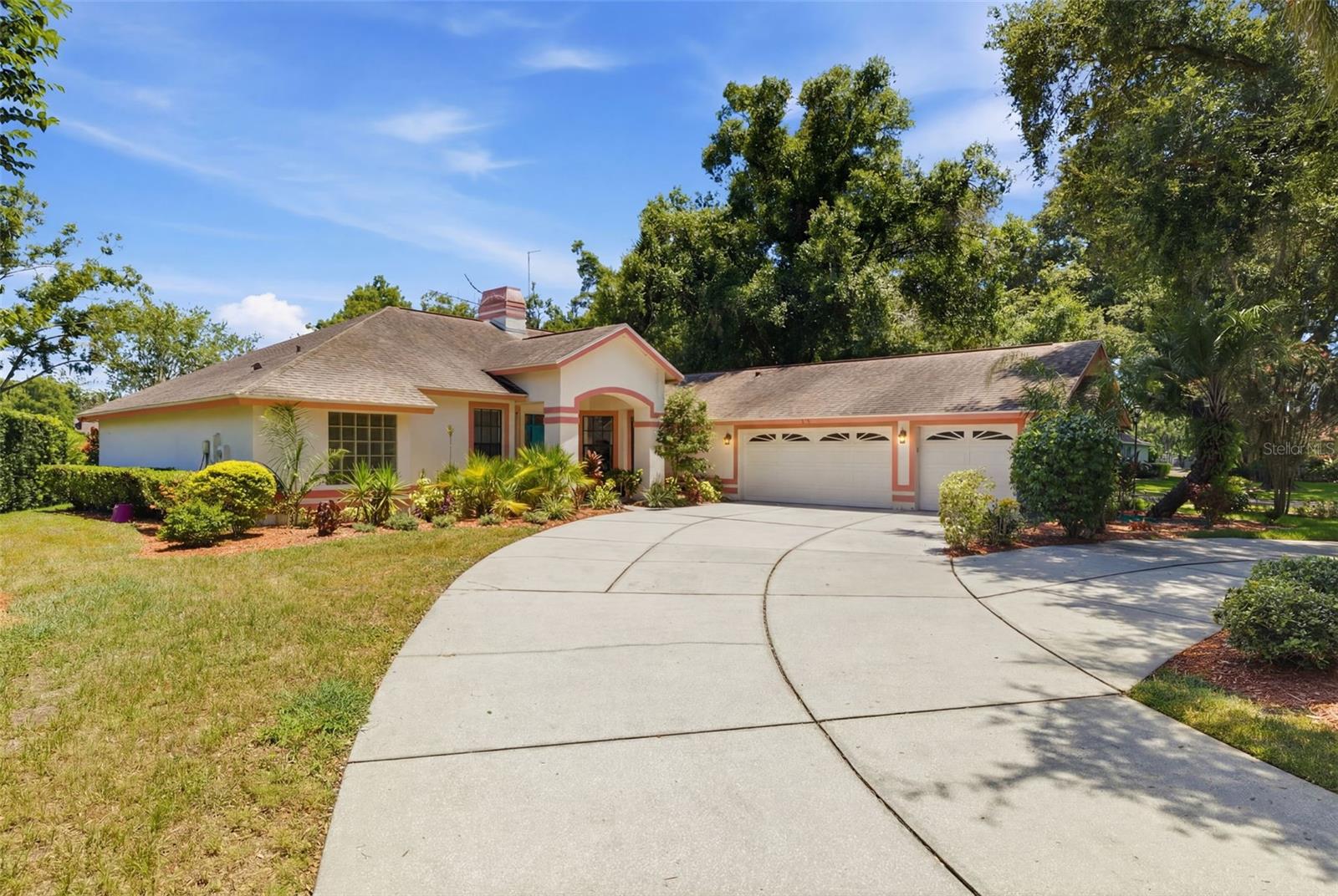 This 4-bedroom, 3-bathroom pool home offers 2,242 square feet of living space on a spacious .29-acre corner lot overlooking a peaceful pond in the heart of Lutz.

Lovingly maintained by its original owner, the home features laminate wood flooring throughout the main living areas, a formal living room, a formal dining room, and a spacious family room with a cozy fireplace, creating plenty of room for both everyday living and entertaining. The kitchen is equipped with newer appliances, including a stove and dishwasher.

The split-bedroom floor plan offers privacy and flexibility. The primary suite is tucked away on one side of the home and features sliding glass doors leading directly to the pool and lanai. On the opposite wing of the home, two secondary bedrooms share a full bathroom, making it an ideal setup for family or guests. A fourth bedroom is located at the rear of the home and features its own en suite bathroom with direct access to the pool deck, making it perfect for guests, multigenerational living, or a private home office.

Step outside to your own private retreat. The screened pool and spa overlook the pond and sit on a large corner lot that offers both space and privacy. Whether you're hosting family and friends, enjoying a quiet morning by the water, or relaxing in the spa at the end of the day, this backyard is designed for Florida living.

The roof was replaced in 2018. With solid construction, a highly functional layout, and room to add your own personal style, this home is ready for its next owner to make it their own.

Located within the gated community of Chapman Manors, residents enjoy access to tennis courts, basketball courts, a playground, park, and fishing opportunities. With no CDD fees and a convenient location near shopping, dining, major highways, Tampa International Airport, downtown Tampa, and the Gulf beaches, you'll enjoy the perfect combination of privacy, convenience, and lifestyle.