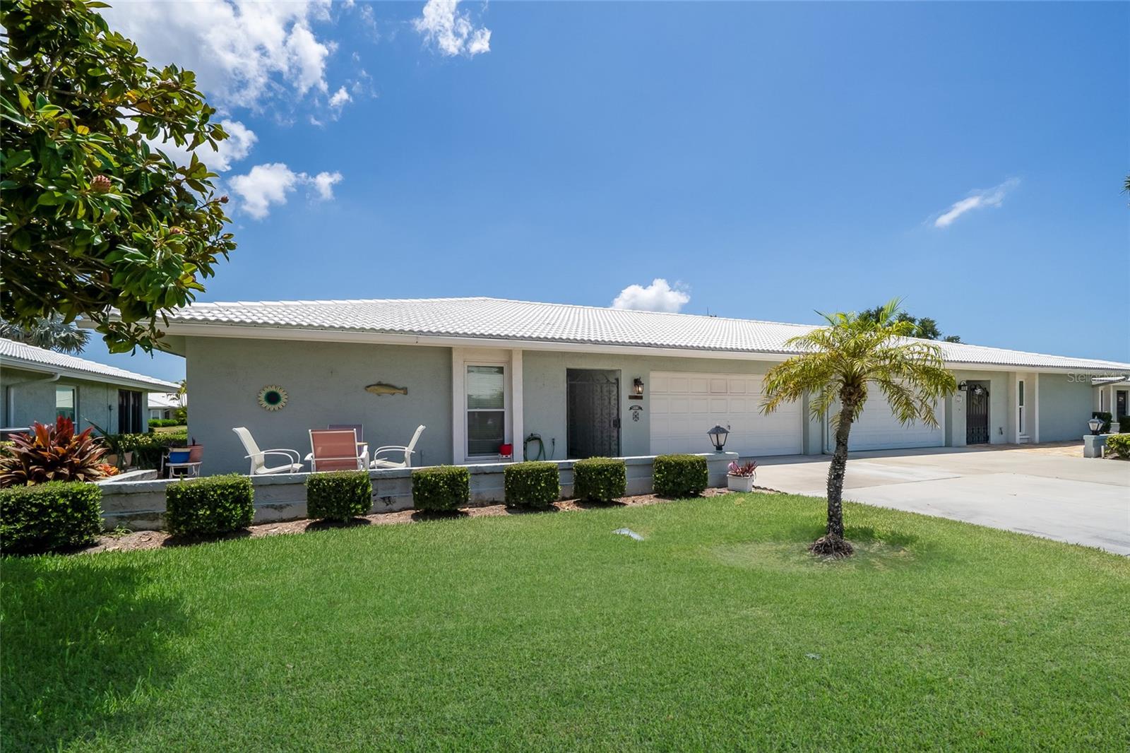 Fantastic opportunity to be within 10 minutes of beautiful Anna Maria Island! This large 2 bed 2 bath Villa offers a tremendous floorplan equipped with a large updated Kitchen featuring Granite Countertops. You'll enjoy the spacious Living Room that opens up to the Dining and over 300 sq ft of Florida Room offering an abundant amount of natural light. Large primary bedroom with two closets and lots of natural light. Upgrades include Hurricane Impact Windows throughout and a 2024 AC unit. Laundry Room/Mudroom/Office nook adds another usable space in this large villa. A 2 Car-Garage gives you plenty of storage and parking. Village Green is a highly sought after 55+ community that offers maintenance free living with lawncare, cable, and internet included within your HOA fee. Walk out your back door and just steps to your Heated Pool and Shuffleboard. Conveniently located in West Bradenton with easy access to SRQ Airport, downtown Bradenton, and our World Class Beaches!