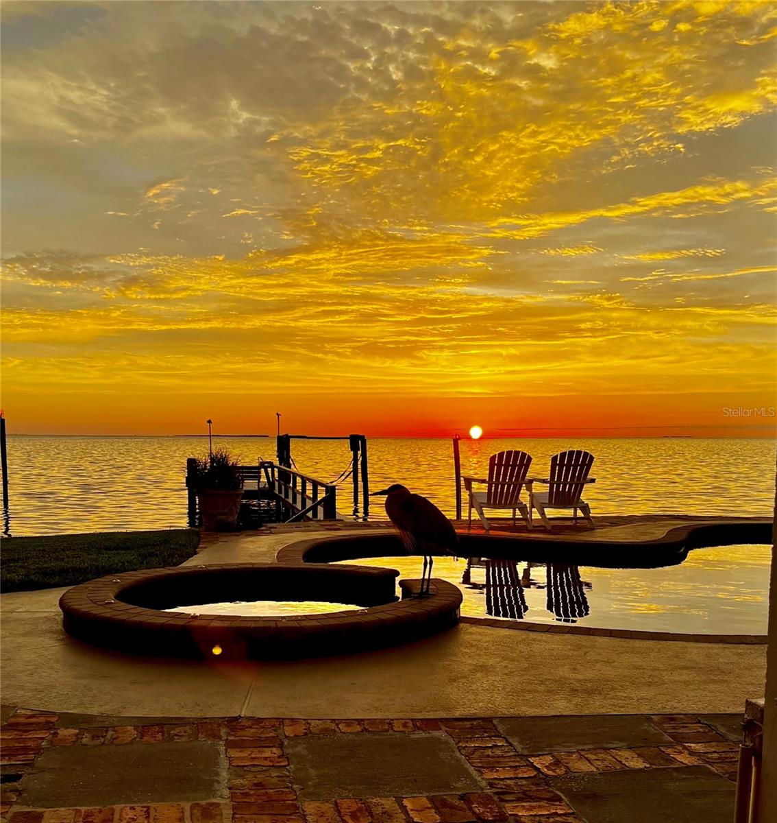 Few homes in Florida stop you at the door. This one does — unobstructed Gulf views stretching to the horizon, with front-row seats to the kind of sunsets that make people never want to leave Crystal Beach.

Welcome to one of Pinellas County's most beloved coastal villages, where timeless Old Florida charm meets a true community lifestyle. Golf-cart friendly and rich in history, Crystal Beach offers a Gulf-front park shaded by century-old Oaks, a fishing pier, children's activity center, a quaint seaside church, and direct access to the 54+ mile Pinellas Trail. Golf cart parades, holiday block parties, concerts in the park, and sunset gatherings at the pier — this isn't just a neighborhood, it's a lifestyle.

This exceptional Key West-style home spans 4,163 square feet on an oversized 0.31-acre lot. Originally established in 1954, the home underwent a complete ground-up reconstruction completed in 2001 — rebuilt with commercial-grade materials including insulated concrete forms, steel framing, heavy-gauge steel studs, and four independent HVAC systems. Buyers benefit from the charm and legacy of a historic Crystal Beach address with the structural integrity and insurance profile of a home effectively built in the 21st century.

The chef's kitchen is appointed with a SubZero refrigerator, dual Décor convection ovens, a six-burner gas and electric cooktop, warming drawer, 48-inch range hood, tankless water heater, and is plumbed for a second dishwasher. It opens seamlessly to the family room, where soaring ceilings and a stone fireplace anchor the space — with the Gulf as your constant backdrop.

The second-floor primary suite is a true retreat, featuring vaulted exposed-beam ceilings, dual walk-in closets, and a spa-style bath with a double-head steam shower, soaking tub, dual vanities, and a private water closet. A generous window seat flows to a private balcony with uninterrupted Gulf views — the perfect place to end every day.

Outside, tropical landscaping — including banana and mango trees — surrounds a temperature-controlled PebbleTec saltwater pool and spa with sun shelf. The private dock, built with lifetime-warranty WearDeck composite planks, features a boat lift and generous seating. From here, Anclote Key Lighthouse, Three Rooker Bar, and Honeymoon Island are minutes away by boat — or head south to Clearwater and St. Pete for a weekend of waterfront dining.

Inside, the home is equally suited for fun and function. A music and game room connects to two guest bedrooms with a shared bath. A large fitness studio opens directly to the pool and Gulf — workouts with a view. A loft above the family room is a favorite hangout spot, and a spacious laundry and mudroom adds everyday practicality. The oversized 2.5-car garage doubles as a workshop with built-in storage — and a freestanding elevator provides easy access to the large, fully walkable attic above.

Nearby, the vibrant dining and arts scenes of Dunedin and Tarpon Springs are just minutes away, with two international airports within easy reach.

Whether you're seeking a full-time residence, a waterfront escape, or a generational investment — opportunities like this on the Gulf are genuinely rare. Schedule your private showing today, and welcome home to Crystal Beach.
