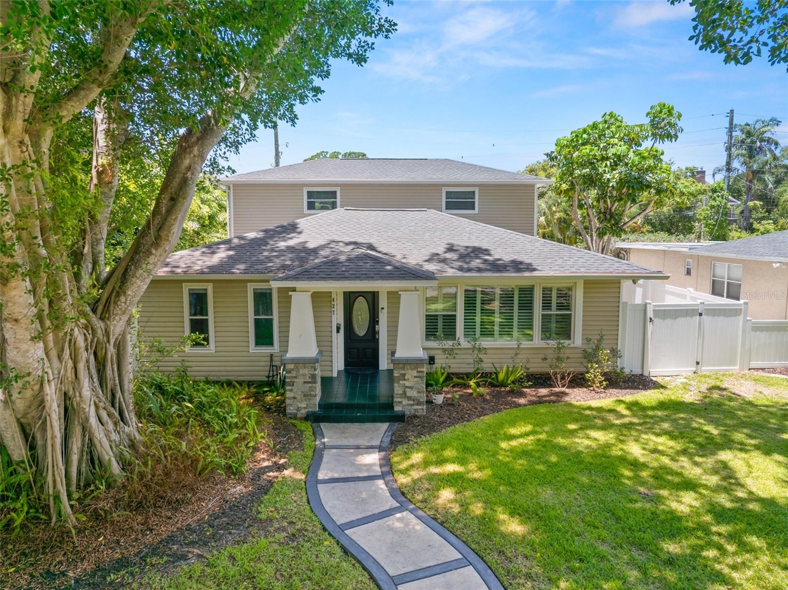 Under contract-accepting backup offers. One or more photo(s) has been virtually staged. Rare opportunity for both charm and luxury in this fully renovated Florida Craftsman bungalow located on Augusta brick-lined Historic Villa Grande Avenue—the original causeway to St. Pete Beach. As a result, this quiet enclave features oversized lots, extra-wide streets, and distinctive oak-lined medians between homes, a streetscape found in very few areas of St. Petersburg.
Situated in the highly desirable Old Pasadena/Davista area, the home blends timeless Craftsman architecture with sophisticated modern updates and outdoor living designed for the Florida lifestyle. Positioned in Flood Zone X500, the property sits high and dry with no flood insurance required.

Architectural details throughout the home showcase the Craftsman aesthetic with modern touches including wide plank hardwood flooring, plantation shutters, crown molding throughout the living areas, oversized baseboards, and Craftsman-style window casings. At the heart of the home, the stunning remodeled kitchen features a glass-and-marble backsplash, a breakfast bar, upgraded stainless steel appliances, and seamless access to adjoining gathering spaces.

A spacious family room with a gas fireplace opens through French doors to a private backyard retreat. The outdoor oasis features a pebble-finished saltwater pool, leathered Akoya marble decking, vinyl privacy fencing, and a dedicated dog run with artificial turf—perfect for four-legged family members.

The Primary Suite encompasses the entire second floor, creating a private sanctuary complete with multiple closets, a balcony overlooking the pool, and a spacious remodeled spa-inspired bath featuring a soaking tub and separate shower featuring top of the line finishes.

Downstairs bedrooms are spacious and finished with elegant 12" x 24" marble-look porcelain tile laid in a herringbone pattern, adding both style and durability. Additional highlights include an oversized two-car garage with alley access and ample room for vehicle, boat, or RV storage. Zoning allows for the potential addition of an ADU, offering flexibility for guests, multigenerational living, or rental income.

Recent improvements include a dimensional shingle roof (2021), newer A/C system, enhanced attic insulation, LED lighting throughout, and natural gas connections for the fireplace, natural gas fire pit, and a dedicated location for an outdoor kitchen with gas line in place.

Enjoy close proximity to the Gulf beaches, downtown St. Petersburg, Central Avenue, Pasadena shopping and dining, the Pinellas Trail, and more. The property offers easy access to some of the area's most popular destinations while preserving the character, charm, and prestige of one of St. Petersburg's most distinctive historic neighborhoods.