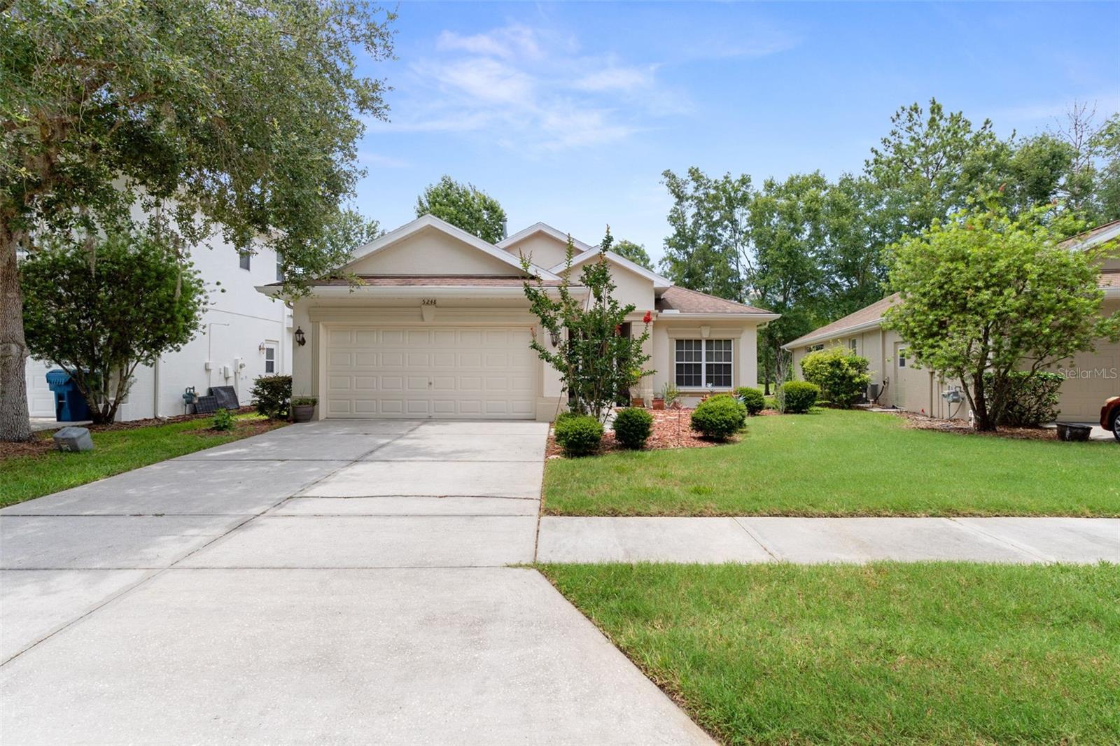 WELCOME HOME to maintenance-free living in one of the area's most desirable gated golf course communities with no CDD's! This spacious 3-bedroom, 2-bath home offers nearly 2,200 square feet of thoughtfully designed living space and is ideally situated on a quiet circle with minimal traffic, providing exceptional privacy with no front or rear neighbors.

From the moment you arrive, you'll appreciate the inviting curb appeal, highlighted by a glass front storm door and a NEW ROOF scheduled for completion at the end of June 2026. Inside, abundant natural light fills the home, creating a bright and welcoming atmosphere throughout. Beautiful wood-look ceramic and porcelain tile flooring combines the timeless appearance of hardwood with the durability and easy maintenance of tile—perfect for Florida living. These floors are resistant to moisture, scratches, and stains, making them an excellent choice for busy households and pet owners alike.

The chef-inspired kitchen is the heart of the home, featuring an abundance of cabinetry, expansive counter space, stainless steel appliances, and a large center island with a granite countertop. The island provides additional storage with extra drawers and cabinets while also offering the perfect gathering space for family and guests.

Retreat to the oversized primary suite featuring elegant double-door entry, separate his-and-her closets, and a spacious en-suite bath complete with dual sinks and a large walk-in shower. Bedrooms two and three are generously sized, with one offering a large walk-in closet rarely found in secondary bedrooms.

Step outside and enjoy peaceful views of the golf driving range with no rear neighbors to interrupt the scenery. Whether enjoying your morning coffee or relaxing after a round of golf, you'll appreciate the tranquility and privacy this location provides.

Additional upgrades and features include:
• NEW Roof (June 2026)
• AC replaced September 2019
• Gas water heater replaced July 2018
• Washer and gas dryer included
• Lawn maintenance included in HOA, with an option to opt out and reduce HOA fees

Residents enjoy access to outstanding community amenities including a championship golf course, driving range, pickleball courts, on-site restaurant, and weekly social events at The Grill, making it easy to stay active and connected with neighbors.

If you're looking for privacy, low-maintenance living, modern updates, and a vibrant golf course lifestyle, this exceptional home checks all the boxes.  Call today!