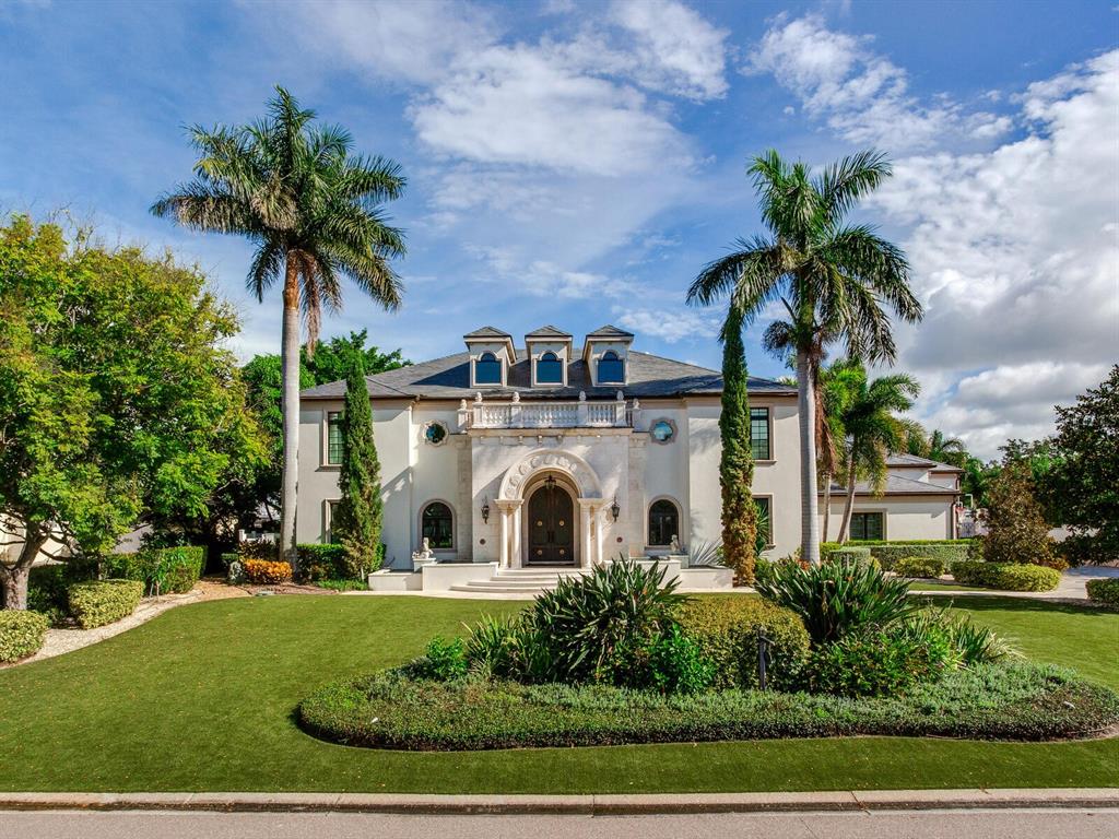 Please click the button to see the 3-D Matterport video tour. 4923 New Providence Avenue is a truly magnificent estate that only comes around once
in a blue moon. The quality, design, and attention to detail are unparalleled and
unlike anything else on the market. The home sits on an oversized lot in
Culbreth Isles at 21,312 square feet with imported Italian turf stretching the length of
the property. You immediately get the sense of the grandeur of this home as soon as you
enter through the 10-foot tall double steel doors and are immediately greeted by soaring
ceilings of 20 1/2 feet and a large wedding spiral staircase, inspired by the St. Regis
Atlanta (see entrance photo). The living room, visible from the entrance, is also 20 1/2
feet high. Which is centered by a solid stone fireplace, carved and shipped in one piece
from Turkey, that took a forklift driving through the front door while the home was
being built to install. Other one-of-a-kind features of the home include exceptional soundproofing in every single exterior wall to make sure you are not bothered by the outside
world while enjoying your home; a glass elevator with Carrera marble lined shaft that
looks up to a Chihuly inspired blown-glass fixture; a one of a kind cinema room, a
SONOS compatible system throughout the house, an industrial-sized generator that can
power the entire Estate for up to 2 weeks, the highest rated hurricane proof windows
throughout, and much more. All bathrooms upstairs have steam showers – nearly every toilet in the home is a TOTO toilet - the
master bathroom comes with two. Although there are four bedrooms and six full
bathrooms, the 13 1/2 foot ceiling cinema room has another bathroom which could
easily be converted to another master or even a large ballroom/entertainment space.
The fitness room can also easily be converted into another bedroom; giving buyers the
option for a six-bedroom home. The kitchen is an oversized gourmet chef’s dream with two full
ovens and 6 burners, all WOLF appliances that sit adjacent to a climate-controlled
wine cellar and butler's pantry. The house is full of redundancies to make sure you never
are short on space, such as having 3 full-size subzero refrigerators, 5 freezers and 2
refrigerator drawers in the kitchen and pantry alone. The fully custom kitchen is also
outfitted with a massive 10-foot island for seating, a restaurant-grade solid 5x5 foot
wood butcher's block, and banquet restaurant-style seating by windows that gazes out
over the exotic trees and backyard water oasis. This home also has a full three-car airconditioned garage with
height for car lifts and extra parking spaces for at least 12+ guests in the driveway. The
elaborate and exclusive outdoor entertainment space is highlighted by a cascading
infinity edge saltwater pool which is surrounded by a crushed coral deck that withstands the heat. 
Finally leading to the bay are two cement docks (never
to be replicated in Culbreth Isles) that can easily house a 50-foot boat on the 30,000
pound-rated boat lifts, alongside a jet ski lift for two skis. From the home's concrete dock, one can see the open Bay.