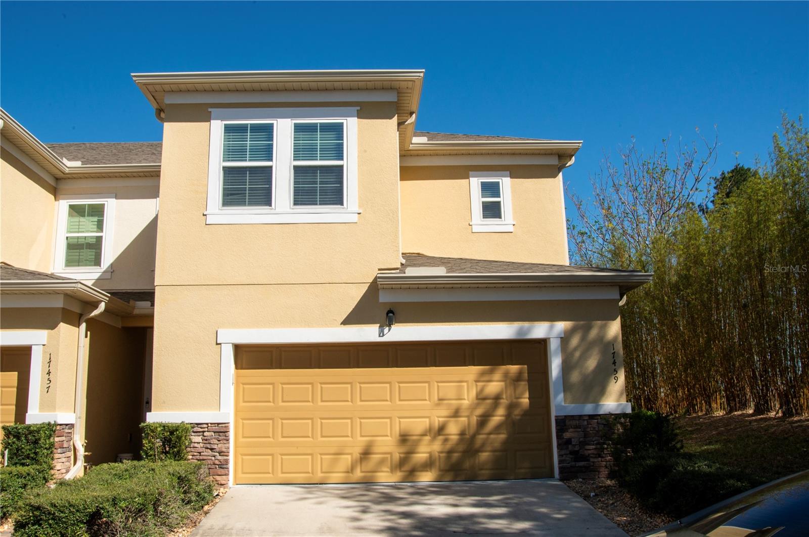 This is a fabulous 2 story town home located in the rolling hills of Clermont. Beautiful 3 bedroom plus flex room home with covered lanai andcovered balcony off Master bedroom. This home features 42" cabinets and tile throughout the dining, kitchen and living room. 2 car garagecustomized with epoxy flooring and large customized mirrors, perfect for an at home gym with opener included. The Magnolia Pointe communityamenities include a clubhouse, fitness center, outdoor pool, playground, pickle-ball courts, tennis and basketball courts, picnic area, dock andboat ramp to beautiful Johns Lake. Magnolia Pointe is guard gated 24/7 conveniently located close to the turnpike (exit 272), Costco, shopping,dining, hospitals and schools. End unit with no rear neighbors and tall bamboo on side for added privacy. Quiet location at end of street.