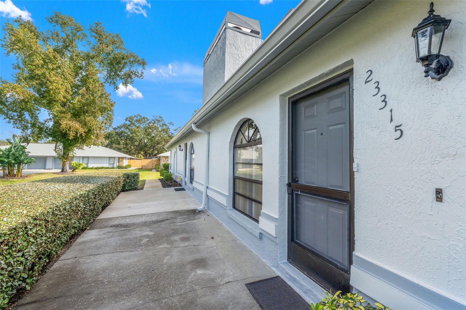 Welcome to Club Villas Condominiums—a beautifully maintained 2-bedroom, 2-bath home with an attached 1-car garage. The spacious living and dining area features vaulted ceilings and a charming stone, wood-burning fireplace. The large eat-in kitchen offers plenty of cabinet and counter space plus a pantry area. The primary suite includes dual sinks, a walk-in shower, and a generous walk-in closet. Impact-rated windows and doors, along with new roofs (July 2024) covered by the association, provide peace of mind. Enjoy a maintenance-free lifestyle with access to a clubhouse, pool, fitness center, tennis, racquetball, basketball, and shuffleboard courts, plus walking trails and a playground. Conveniently located near top restaurants, shopping, beaches, and theme parks—this condo is the perfect place to call home!