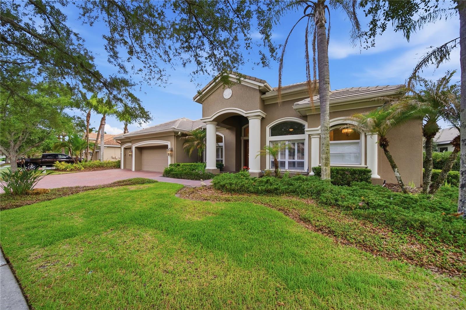 Nestled within the gated enclave of Lancaster in Tampa Palms, this exceptional estate residence offers an elevated blend of timeless elegance and modern luxury. Featuring 4 bedrooms, a private office, 3.5 baths, and a 3-car garage, this meticulously curated executive pool home is gracefully positioned on a serene pond-front homesite. Thoughtfully redesigned with impeccable attention to detail, the residence showcases soaring ceilings, rich hardwood flooring, bespoke millwork, and picturesque water views throughout.The gourmet chef’s kitchen is a true centerpiece, appointed with an expansive leathered granite island, custom cabinetry with crown molding, double wall ovens, gas cooktop, dual wine refrigerators, and designer lighting selections that create both warmth and sophistication. The spa-inspired bathrooms feature luxurious granite finishes, refined fixtures, and elegant design elements throughout.A desirable split-bedroom floor plan provides both comfort and privacy, including two secondary bedrooms connected by a beautifully updated bath, a secluded guest ensuite, and an indulgent owner’s retreat complete with a sitting area, custom walk-in closet, and a lavish bath featuring a soaking garden tub and oversized walk-in shower.
Designed for effortless indoor-outdoor living, the expansive pavered lanai overlooks a sparkling resort-style pool and tranquil pond views — an idyllic setting for entertaining or quiet relaxation.Recent enhancements include upgraded landscape lighting, AC (2021), water heater (2022), pool motor (2022), water softener, and a beautifully reimagined laundry room.Residents enjoy exclusive access to Club Tampa Palms amenities including resort-style pools, fitness center, spa, sauna, tennis courts, and more. Ideally located near premier shopping, fine dining, Moffitt Cancer Center, VA Medical Center, USF, and offering convenient access to downtown Tampa via I-75 and I-275.A rare opportunity to own an impeccably maintained luxury residence in one of Tampa’s most sought-after gated communities.