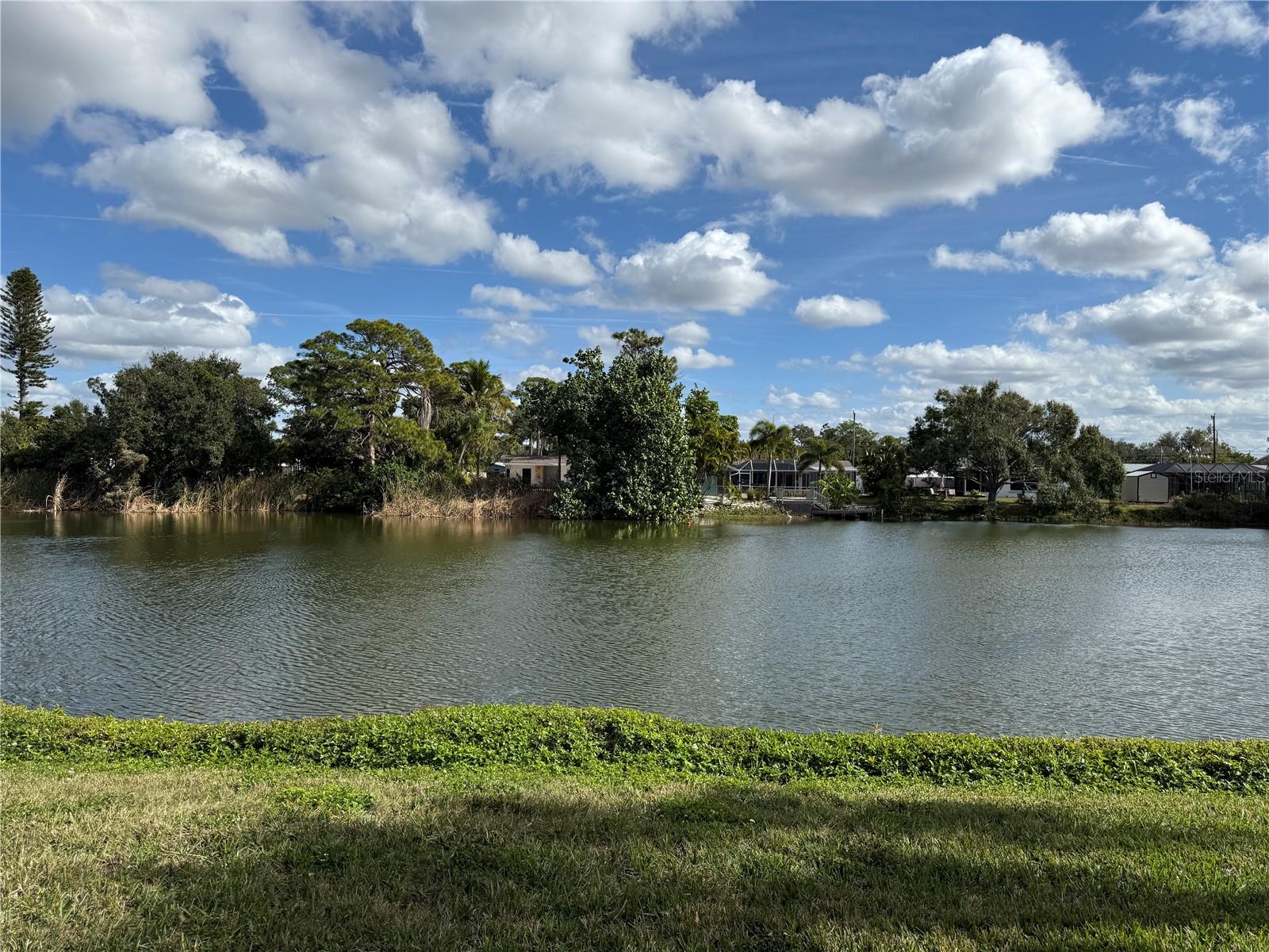 Location! Location! Location! Only 3.5 miles to the World Famous Siesta Key Beach, with its fine sugary quartz sand. This much sought after 2-bedroom 2 bath unit is on the ground floor, overlooking the vast expanse of a natural spring fed lake with very pleasant view. The screened lanai faces east. Unit is bright and airy.  Unit was updated in 2012 with vinyl floors, kitchen cabinets, granite counter tops and updated bathrooms. Ashton Lakes is located on 33 acres of luscious greenery, 4 lakes, 2 heated pools, one with lap lane, 2 tennis courts with 2 pickle ball courts on each, shuffleboard, clubhouse and other amenities. Close to I-75, trte.41, hospitals, schools, restaurants and shopping. We are also connected to Merchant Mart shopping center with CVS, ACE hardware, restaurants, and the famous Detwiler Farm Market. Roof 2009. Come be a part of this friendly community....