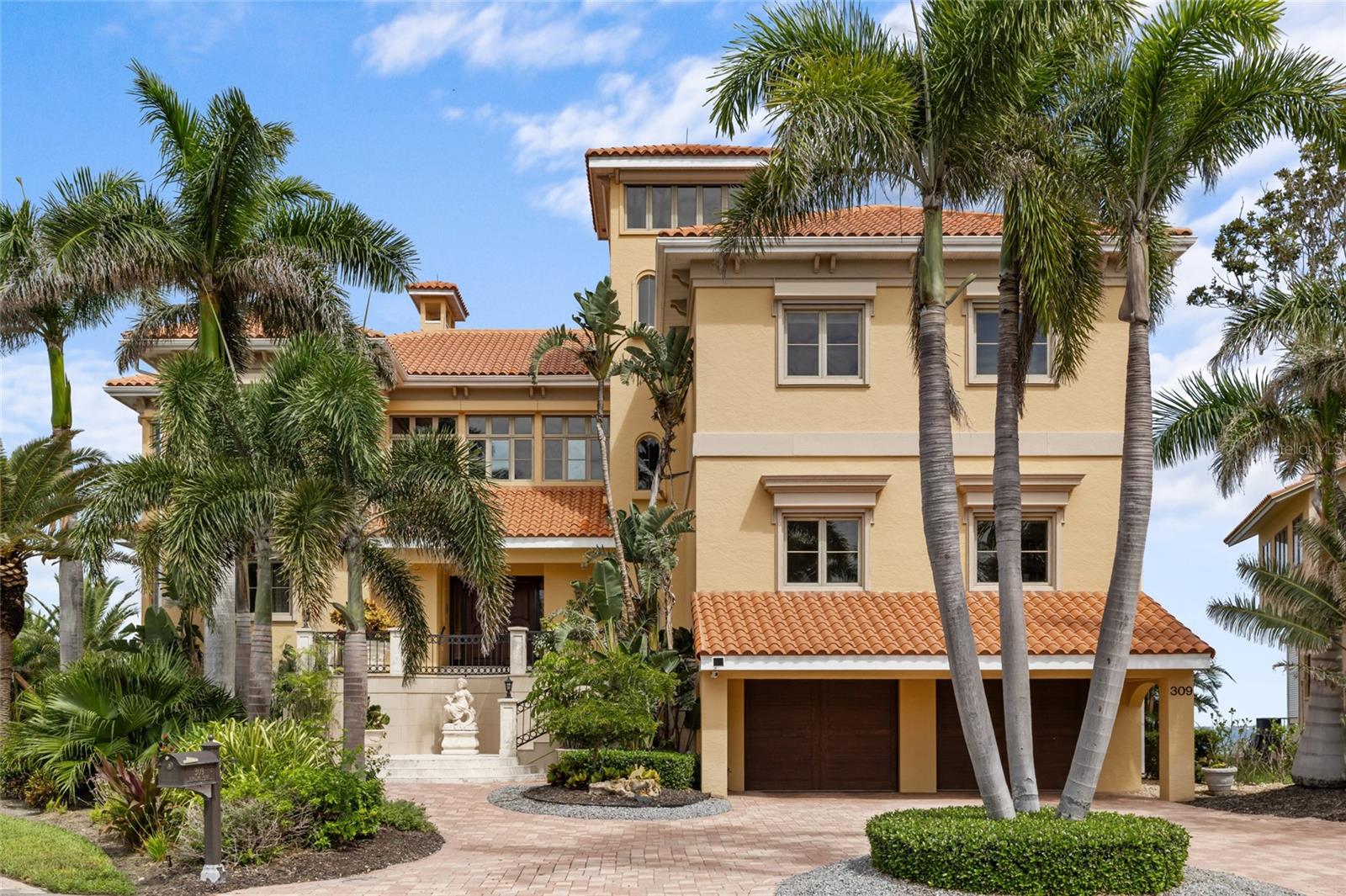 The Seller is willing to consider all reasonable offers including seller financing. Discover one of Sarasota’s best bayfront values with sweeping 270° views of Sarasota Bay, Ca’d’Zan (John Ringling's estate), Longboat Key, and spectacular sunsets. Located on a private cul-de-sac in Ringling Point, this 7,000 sq. ft. estate offers privacy, 17-ft elevation, and direct sailboat water with no fixed bridges, just minutes from downtown. The residence features 5 bedrooms, 3 full and 2 half baths, multiple living areas, soaring 24-ft ceilings, walls of glass framing endless water views, a fireplace and a full-service bar. The chef’s kitchen has custom cabinetry, premium appliances, and a spacious island overlooking the family room with expansive terraces. The owner’s retreat spans an entire wing with private sitting area and fireplace, spa-inspired bath, oversized dressing room, wine room, and full-length terrace. The guest suites, flex rooms, a recording studio, and 4-car garage add versatility. The resort-style outdoor living areas feature a lagoon-style pool, spa, covered terraces, and private dock ideal for yachts and sailboats. With its rare combination of views, quality, and location near downtown, beaches, cultural venues, and SRQ Airport, this estate is a true Sarasota legacy property.
