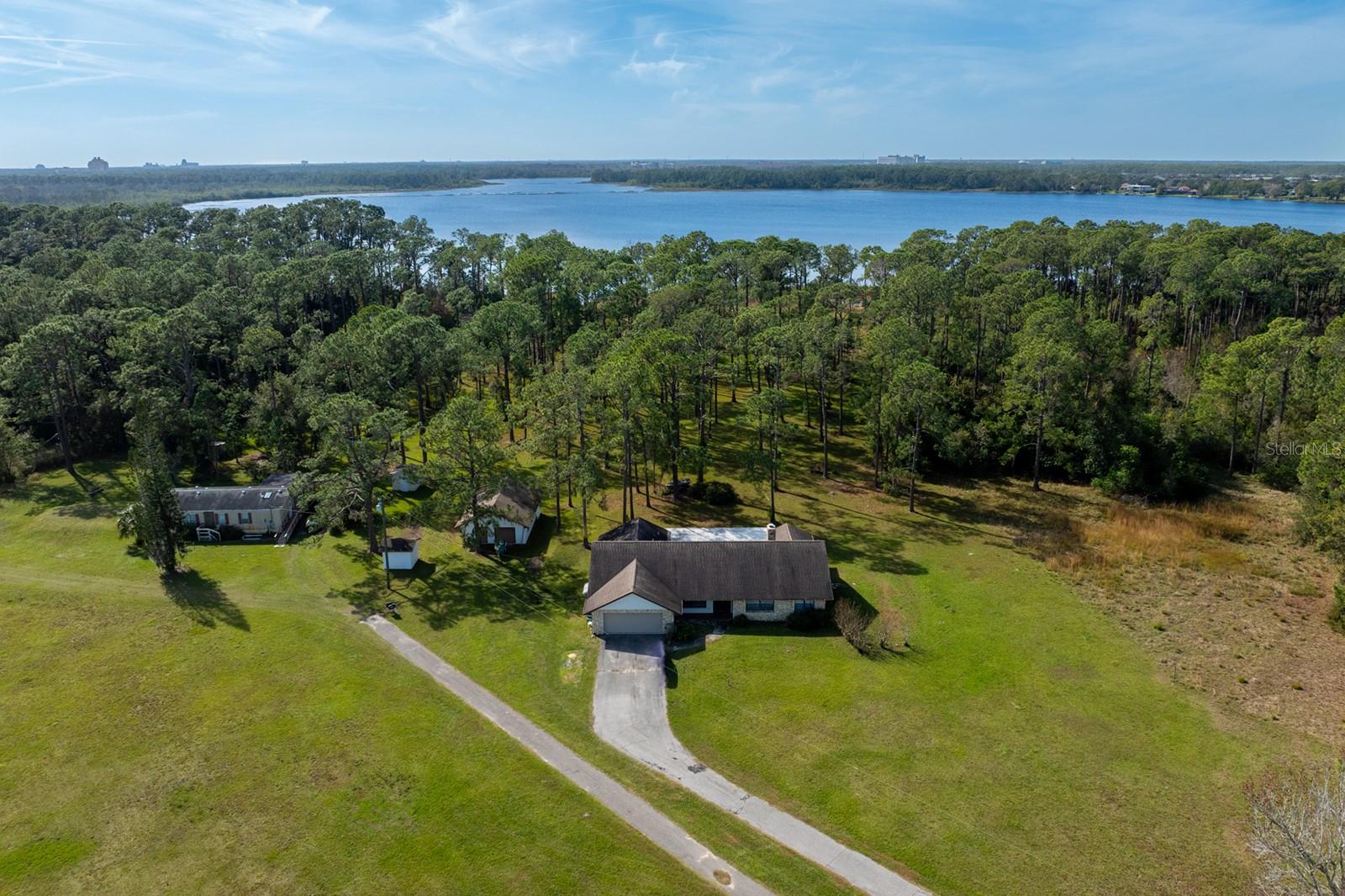 Privately positioned on Lake Mabel, this rare lakefront offering includes two contiguous parcels sold together, totaling approx. 9.47± acres, with direct lake frontage and estate-level privacy in a tightly held luxury waterfront setting. A private-lake environment supporting a premier watersports lifestyle, surrounded by premier estates and a protected natural shoreline. No public boat ramp is managed by Orange County on Lake Mabel, reinforcing the private, resident-driven character of the lake.

Suited for a gated legacy estate or multi-generational compound. Zoned R-CE, supporting an equestrian lifestyle as permitted. Unwind with warm Florida sunsets and Magic Kingdom fireworks—visible from the property—creating a truly magical backdrop for evenings on the lake.

Ideally situated between the Lake Butler Chain of Lakes and the Golden Oak area at Walt Disney World, within a corridor of established and emerging luxury, including Lake Sheen Sound, and in close proximity to Isleworth and Windermere Preparatory School. Existing residence and improvements convey as-is. Future use and development subject to zoning, environmental constraints, and approvals.

Offered only as a combined sale of two parcels: 8822 Winter Garden–Vineland Rd (Parcel ID: 32-23-28-7778-00-030) and 8834 Winter Garden–Vineland Rd (Parcel ID: 32-23-28-7778-00-020).