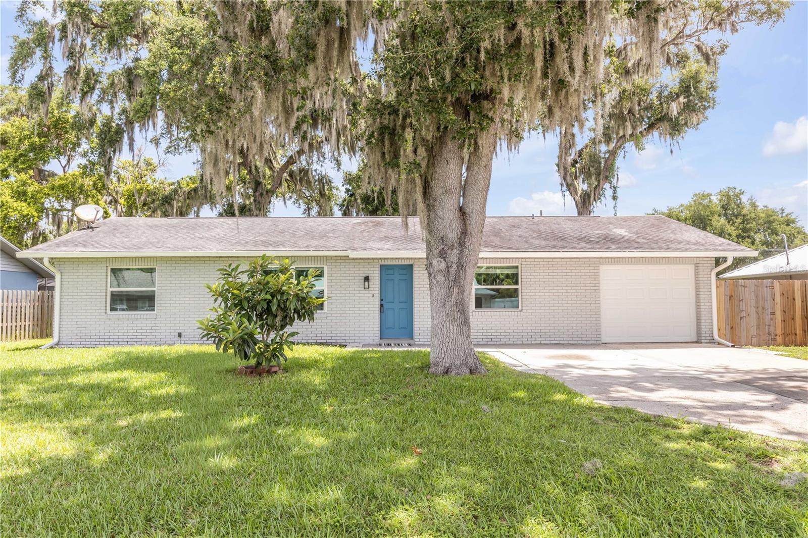 Interest rate buy down program is available for the first 12 months paid for by the lender at closing. This is a limited time offer that requires Rate Lock before 8/31. Welcome to easy Florida living in the desirable Florida Shores community of Edgewater, where thoughtful updates, a spacious layout, and exceptional value come together. This 3 bedroom, 2 bathroom concrete block home has been beautifully refreshed and is move-in ready, offering the style today's buyers are looking for at an affordable price point. Step inside to find luxury vinyl plank flooring throughout, updated lighting, new ceiling fans, and a bright, open living and dining area highlighted by soaring vaulted ceilings that create an inviting sense of space. The modern kitchen features contemporary finishes, glass-front upper cabinets, exposed shelving, and plenty of workspace, making it as functional as it is stylish. Newer wind-rated windows provide added peace of mind, energy efficiency, and natural light throughout the home. Outside, you'll appreciate the fully fenced backyard with plenty of room to design your dream outdoor living space, add a pool, or simply enjoy the privacy. The oversized lot offers endless possibilities, while the attached one-car garage provides additional storage and convenience. Best of all, this home has remained high and dry with no history of water intrusion, offering added confidence for buyers. Conveniently located near shopping, dining, schools, parks, and just a short drive to New Smyrna Beach, this home delivers an outstanding combination of location, updates, and value. At this price point, it's a rare opportunity to own a home that truly stands out from the competition.