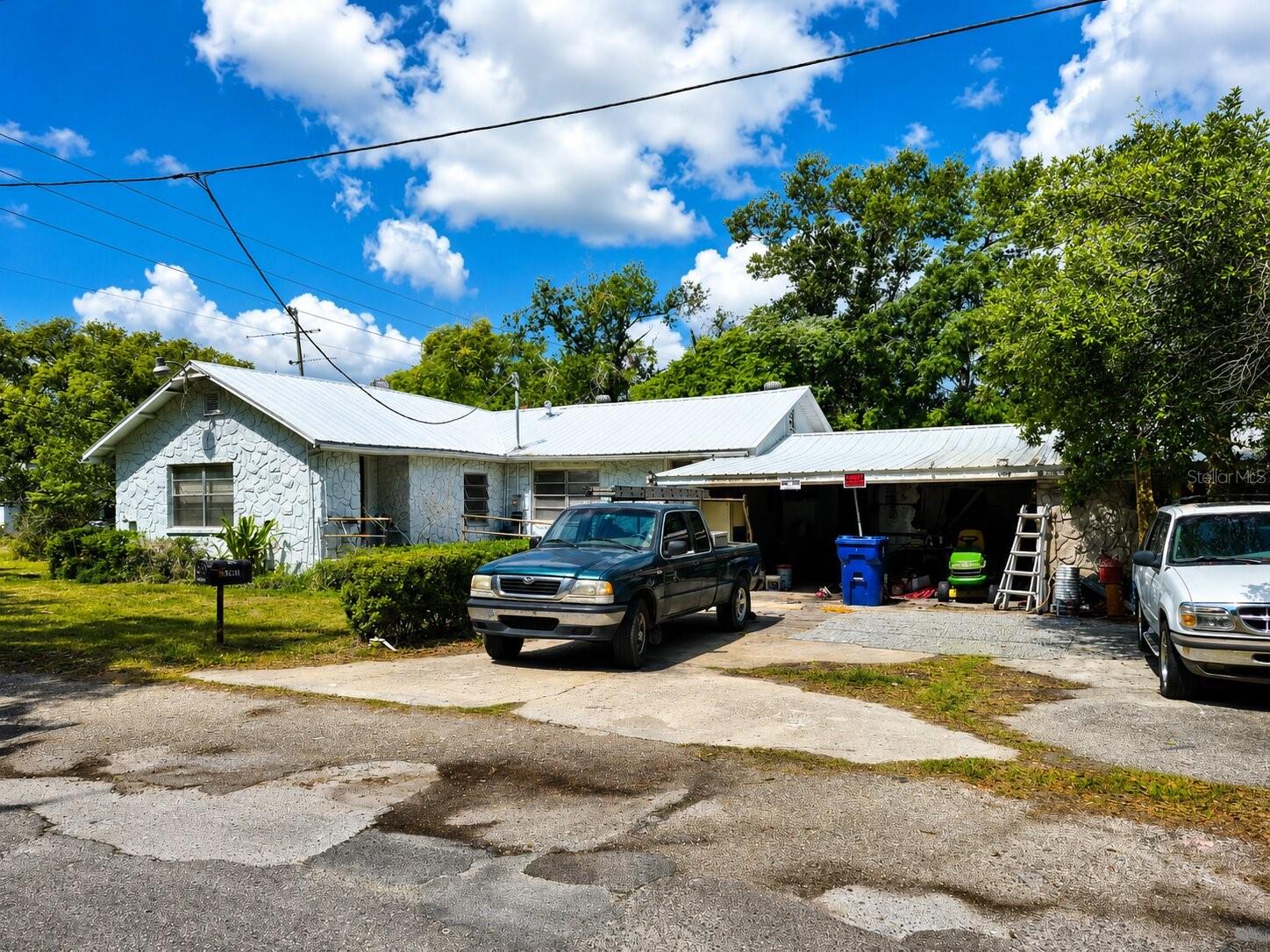 The property is being sold As-Is and requires a total rehabilitation, including interior renovations and improvements. This is a prime opportunity for investors, flippers, or buyers looking for a full renovation project with the potential to build significant equity.

Endless possibilities await on this oversized 0.67-acre cleared homesite in Zephyrhills! This 3-bedroom, 2-bath residence also features a separate office, offering flexible space for a home business, hobby room, or additional living area. An attached garage provides ample room for parking, storage, or a workshop. Also, it has 2 barns with an extended roof for additional storage.

Enjoy the benefits of no HOA or CDD fees while taking advantage of a convenient location close to shopping, dining, schools, and everyday amenities. With easy access to major highways, commuting to Tampa and surrounding areas is simple, all while enjoying the charm of a quieter residential setting.

Bring your vision and contractor—this property offers exceptional potential for the right buyer to transform it into a beautiful home or profitable investment.
