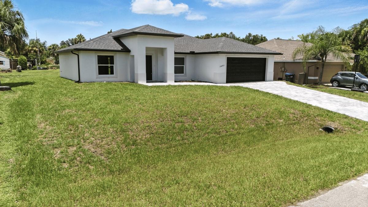 MOVE IN READY! Welcome to your dream home in North Port, FL! This stunning new construction boasts a modern and inviting open floor plan, designed for both functionality and luxury living. With 3 spacious bedrooms and 2 elegantly appointed bathrooms, this custom-built residence offers the perfect blend of comfort and style. Step inside and be greeted by the fireplace in the spacious living room, soaring high ceilings that create an airy and expansive atmosphere throughout the home. The heart of this abode is the gourmet kitchen, featuring granite countertops and top-of-the-line stainless steel appliances. Enjoy privacy and peaceful views in this beautiful home backing onto a greenbelt, with no rear neighbors and added sense of space.This house is Conveniently located on a street with new homes around very close to I-75, shopping, dining and many local beaches. Also located in North Port close to several schools and a short car ride away from Centennial Park and Pool as well as a variety of dining and shopping options including Cocoplum Shopping Center. Take advantage of all the area has to include multiple golf courses and TWO Major League Baseball Spring Training stadiums! Within 15 minutes drive you can be at WELLEN PARK, the new Atlanta Braves Training Stadium, Cool Today Park, and the highly anticipated new Costco store!!! Close to shopping, restaurants, and River. Within 25 minutes drive , you can be at Manasota Beach on the Gulf of Mexico, Aquatic Center, and much more. No HOA/ CDD!!! NO FLOOD INSURANCE REQUIRED! Call now to schedule a showing before this home passes you by!