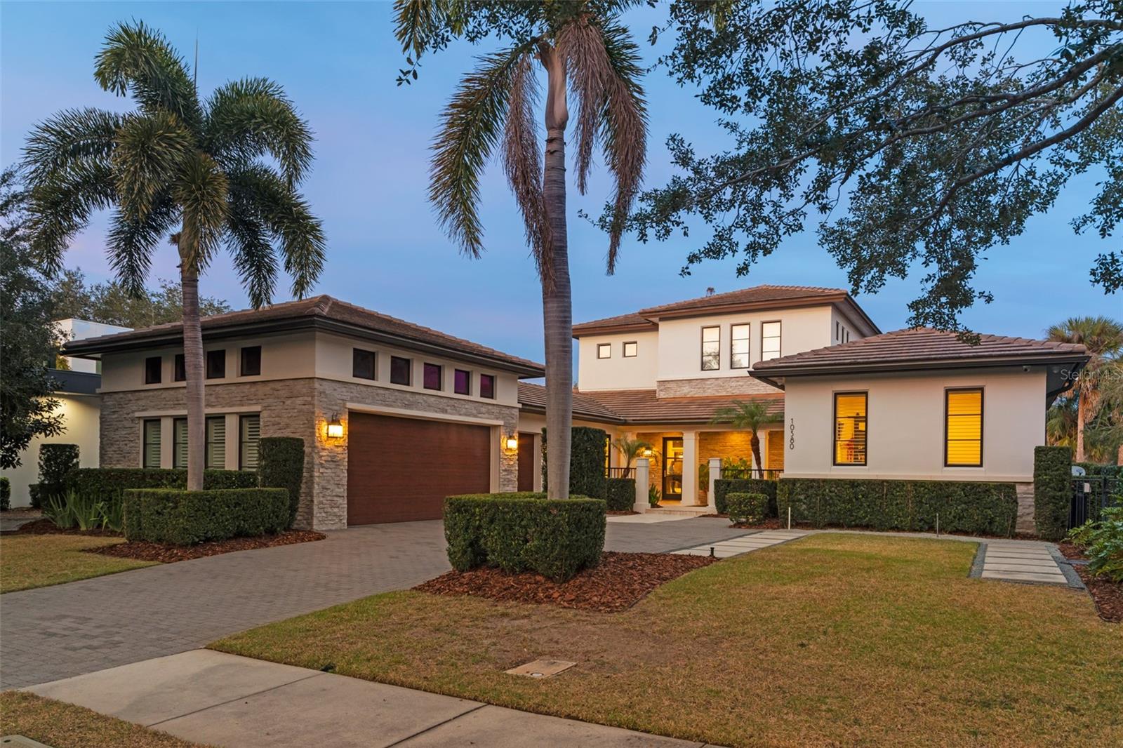 Welcome home to this beautiful custom-built oasis located in Lake Nona Golf and Country Club. This spectacular 5 bedroom, 5 full and one half-bath custom home offers water views, lush landscaping, and an open floor plan.  The entryway highlights a beautiful water feature and the expansive family room showcases wall-to-wall sliders that offer endless views of the saltwater pool and pond.  The home boasts an incredible chef’s kitchen with top-of-the-line appliances, and a butler’s pantry that includes a Thermador wine cooler and has an abundance of storage space. The master suite encompasses the right wing of the home and includes a private vestibule connecting the bedroom and bathroom, a large walk-in closet with built-in storage that houses a washer/dryer, and French doors off the master that open onto a private, covered patio. Also located on first floor is a mother-in-law suite with ensuite bathroom, a dedicated office that is currently being used as a den and so much more.  This lovely home truly has it all, including both a downstairs laundry and an upstairs laundry room, so there is never a need to carry laundry up and down the stairs. On the second floor you will find three large size bedrooms, all with ensuite bathrooms.  The outdoor space of this home is truly spectacular and has beautiful private views of a pond and fountain.  It features a 1000+ square foot covered lanai complete with a built-in outdoor kitchen, tongue-in-groove ceiling and a double-sided fireplace. Located just steps from all the Country Club amenities- you just won’t want to miss this one. Lake Nona Country Club offers world class golfing, and neighborhood amenities such as housekeeping, concierge, and 24-hour security. Lake Nona is located near Orlando International Airport, and is only a short drive from downtown Orlando, Winter Park, and the attractions.