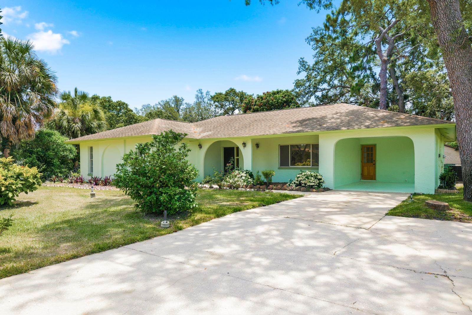 AMAZING LOCATION! NO HOA! Walk to Sunset Beach, schools, and Howard Park. Located in the historic town of Tarpon Springs, this home is situated on just over 1/4 acre.  With 1,928 SF of living space there is room for everyone! Two living areas provide ample room for the whole family, or transform into a 4th bedroom!  The recently updated kitchen overlooks the family room complete with a wood burning fireplace.  This home features a desirable split plan which ensures privacy. Recent updates include: kitchen, guest bath, vinyl flooring, and fresh interior paint. PLUS an indoor laundry room. Enjoy the back yard from the screened-in porch. The spacious yard provides the opportunity to add a pool! NO FLOODING DURING THE HURRICANES according to the seller. ZONE X500!! Tarpon Springs is a golf cart community!