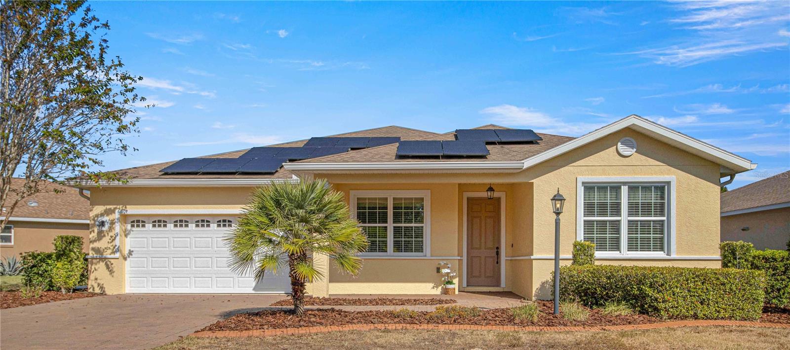 Spacious Move-In Ready Modified Alban Model Single Family Home located on a quiet street in the Windsor West Neighborhood of the Premiere 55+ Gated Golf Community of On Top of the World. This 2 bedroom, 2 bath, 2 FLEX ROOMS, 2+ Car Garage was built in 2014 and backs up to Green Space with an impressive list of upgrades!  Solar panel system to offset your electric bill that is 100% paid off with a transferrable warranty, custom concrete landscape curbing around entire house and gardens, paver driveway & walkway & front porch, 9’4” ceilings, 8 ft. upgraded interior doors, freshly painted inside and out, tile floors throughout most of the home, crown molding in every room, gourmet kitchen with gas range stove top, stainless appliances, custom tile backsplash, wall oven, ample cabinets, quartz countertops, deep sink, spacious prep island with seating, recessed lighting, spacious Great Room, upgraded ceiling fans throughout, large laundry room with cabinetry & sink & folding space, Butler’s pantry just inside the garage door with more cabinets – perfect for party prep space or wine fridge, upgraded interior doors, expanded deep 2+ car garage with golf cart parking, multiple overhead storage racks in garage, tankless gas water heater, water softener, solar attic fan, and much more!  As you step inside this home, please notice the view straight through the foyer & Great Room & out through the screened lanai to Green Space!  The guest bedroom is to the right with hall/guest bath providing privacy for visitors.  Flex Room # 1 is in the front of the home to the left of the foyer.  Flex Room #2 is adjacent to the kitchen/great room. Open Space Concept Great Room – Kitchen – Dining! The master bedroom is in the back left of the home for privacy with en suite bath including step-in shower with custom tile, double sink vanity, and comfort height toilet, and a walk-in closet!  Enjoy the 25x10 screened lanai and the peaceful views! The monthly HOA fee includes basic internet, roof repair, exterior painting every seven years, exterior maintenance and insurance, landscaping, trash, 24/7 guarded gates and all the amenities that OTOW has to offer; three pools (2 outside & 1 inside), two state of the art fitness centers, pickleball, billiards, archery range, corn hole, bocce ball, tennis, shuffleboard, horse shoes, remote control flying field and race cars, 175+ clubs, woodworking shop (extra fee), library, and much, much more! A golf cart community with access to three shopping centers.