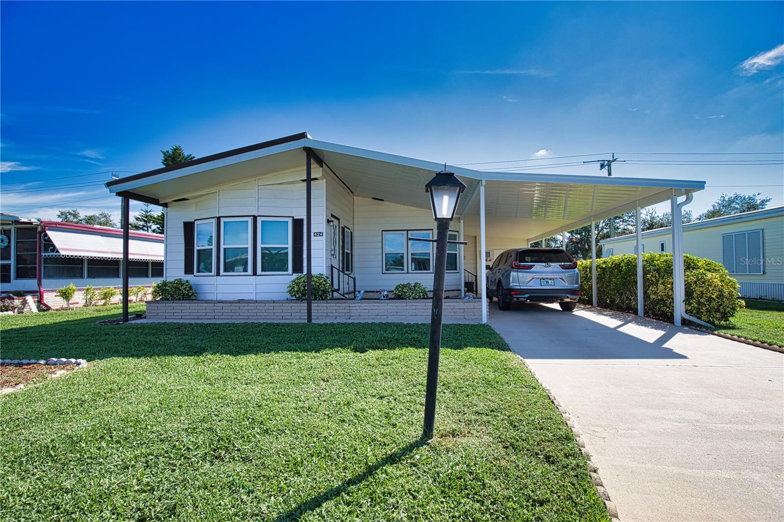 Don’t miss the chance to grab your piece of paradise in this vibrant 55+ community.  This charming two-bedroom, two-bath home is located in a pet-friendly area with plenty of backyard space for your furry friend. A long carport brings you to the utility shed with a washer, dryer, deep sink, work bench, plenty of storage space, and a door to the back yard. Entry to a dining area and the kitchen with appliances. The living room features French doors to the cozy front Florida room, perfect for enjoying your morning coffee or afternoon beverage while basking in the beautiful Florida warmth. The guest bedroom has two built-in double closets, and the guest bathroom features a vanity and a tub/shower. The spacious primary bedroom with a walk-in closet features an ensuite bathroom with a walk-in shower, vanity, and linen chest. The home features laminate flooring, vaulted ceilings, and ceiling fans throughout. The cozy interior of the home is perfect for both relaxing, quiet nights and entertaining your friends and family. This home is a must-see!
La Casa boasts 974 home sites nestled among a variety of native trees with spacious common grounds surrounding our eight lakes. Our lots average a generous 60' by 80'. Providing the ultimate lifestyle on Florida’s Gulf Coast, La Casa is located between Sarasota and Fort Myers and is a boater's dream. It is convenient for shopping, sightseeing, golfing, fishing, and boating, as well as all the culture and elegance the Southwest Florida area is noted for. Residents and visitors enjoy the warmth of Southwest Florida winters in a relaxed and unhurried environment far removed from the hustle of Florida’s east coast. You’ll be surrounded by mature, lush landscaping, which demonstrates the utmost level of care our property receives from residents and management.  Wireless Internet (Wi-Fi) is available at the Clubhouse, Activity Building, and Recreation Hall area, where our pools & spas are located, so you can catch some rays while you catch up on your email! Sound enticing? La Casa is a friendly, family community. You will be away from the hustle and bustle, except when you want to be part of it. Come for a visit to this self-contained oasis and see for yourself why La Casa is the ultimate destination for both snowbirds and year-round residents!