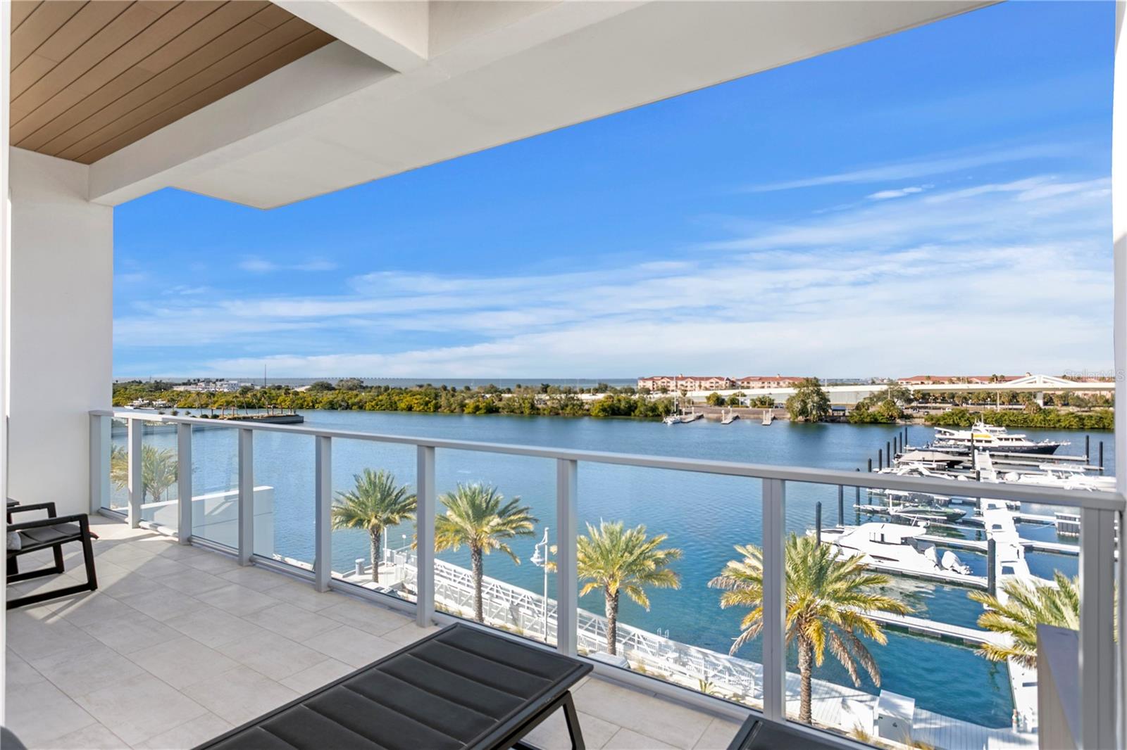 A rare offering at Marina Pointe. The only Harbour Home ever released for resale, a desired corner and one of just seven private residences in the community. This four-level waterfront home lives like a single-family residence with the lock-and-leave ease of a condominium, featuring direct ground entry from three private parking spaces, balconies on every level and panoramic water views. Thoughtful upgrades include new hardwood floors with sound-dampening underlay, an upgraded 2025 HVAC system, new interior doors, a custom beverage station, refreshed kitchen surfaces, whole-home and reverse-osmosis filtration, sound-absorbing wood paneling and impact-rated windows. Level 1 living plus kitchen, Level 2 full primary suite, Level 3 guest suites, Level 4 den with terrace and private spiral stair to the pool. Directly across from the residence is the deeded 40-foot boat slip exclusively assigned to this Harbour Home and required to be purchased with the property for an additional fee. Designed for vessels up to 45 feet with water and electricity, the slip delivers immediate access to open water and is one of Marina Pointe's desirable locations. Resort amenities include the waterfront pool, spa, fitness center, clubroom, grilling areas and marina access. Positioned between Tampa and St. Petersburg, this Harbour Home offers a lifestyle defined by privacy, convenience and direct connection to the Bay. A rare opportunity, available for immediate occupancy.