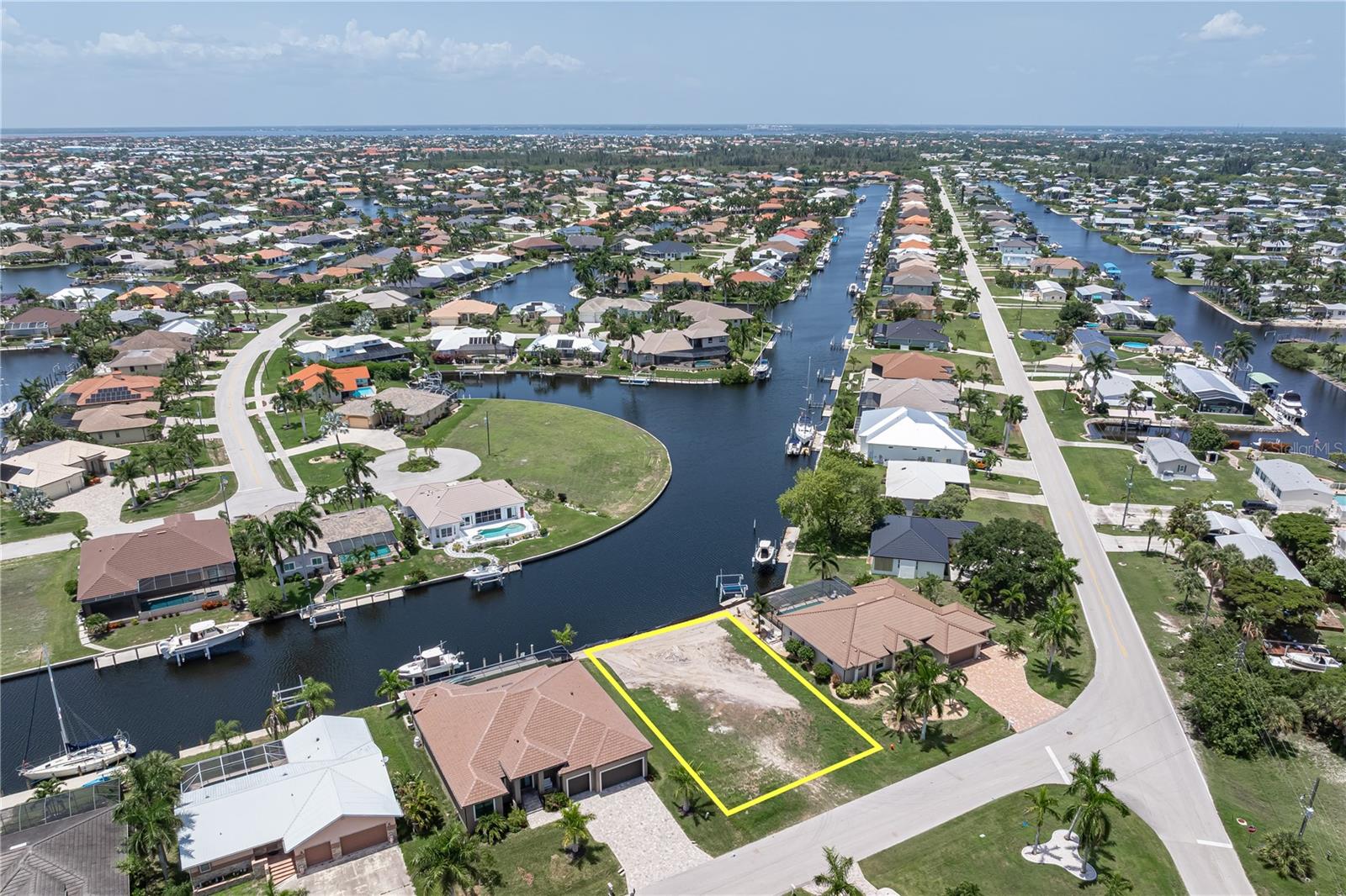 VACANT LOT IN PGI W/VERY QUICK SAIL ACCESS, AN EXCEPTIONAL LONG CANAL VIEW & NEW SEAWALL (2026) – Build your custom waterfront home in Punta Gorda Isles. This sailboat-access lot offers 80 feet of city-maintained seawall, a wide canal view, and quick access to Charlotte Harbor through nearby Buckley's Pass. Prefer a leisurely cruise? Follow the perimeter canal and exit through Ponce Outlet while taking in the scenery along the way. The property measures approximately 80x120x80x120 and provides ample space to design the custom waterfront home you've always envisioned. The northwest rear exposure provides colorful sunset views over the canal while the long water view creates an impressive backdrop for your future lanai, pool, and outdoor living space. Watch boats pass by throughout the day. Or, picture ending the day on your future lanai as the sky reflects across the water. City water and sewer are available. Located near St. Andrews South Golf Club, you can enjoy a morning on the golf course before setting off by boat for waterfront dining, fishing, or exploring Charlotte Harbor and beyond. Fishermen's Village, downtown Punta Gorda, waterfront parks, restaurants, and shopping are all nearby. An optional membership in the Punta Gorda Isles Civic Association provides opportunities to connect with neighbors and enjoy community events. Keep your boat in your backyard, reach open water in minutes, and start enjoying some of the best boating and fishing Southwest Florida has to offer. Claim your spot in paradise today. Seller is open to a land contract.