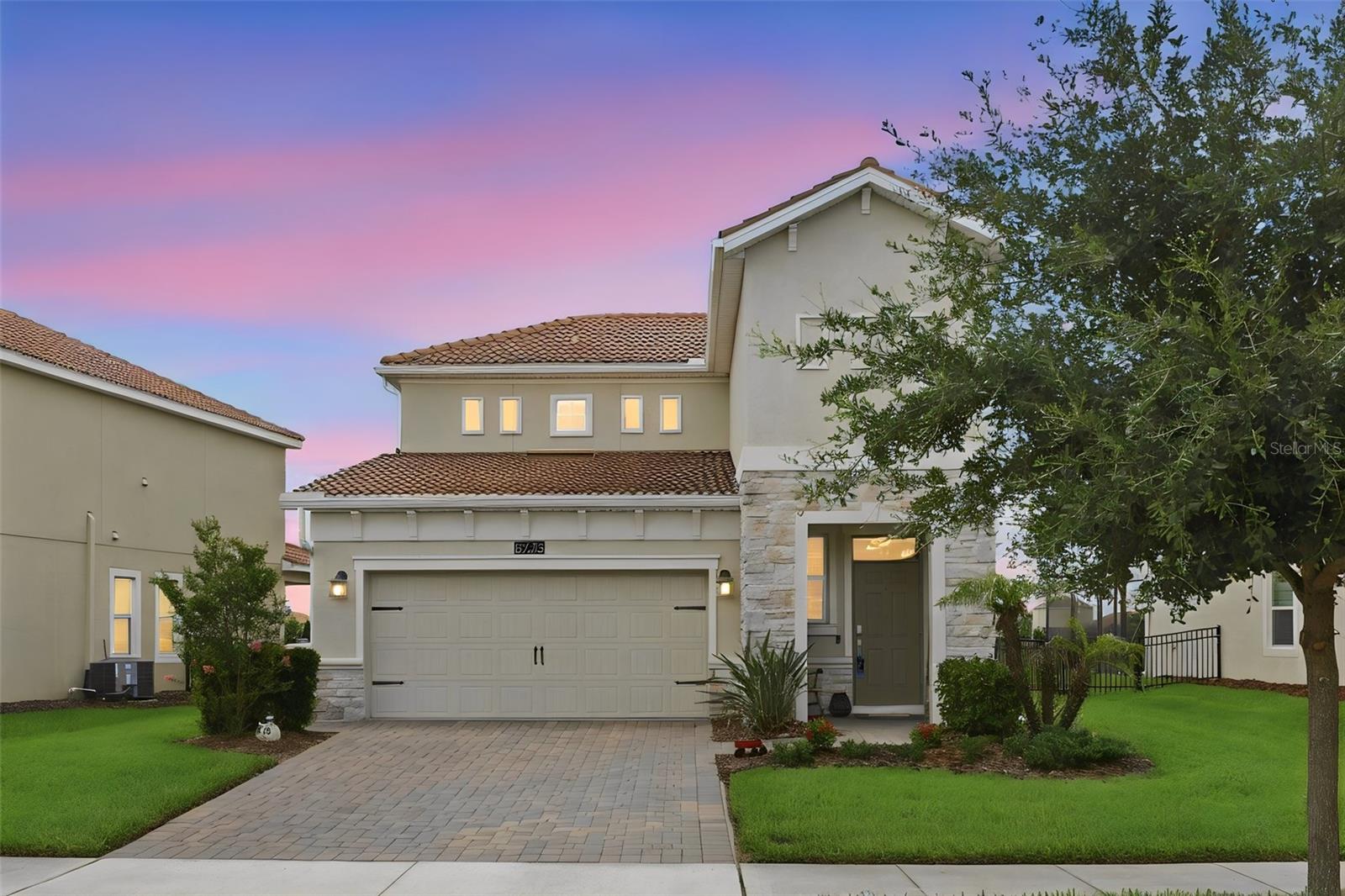 WELCOME HOME all GOLF ENTHUSIASTS, RETIRED PERSONS, and FAMILIES!  This beautifully maintained 3 bedroom, 2.5 bath two story home (with the primary suite on the first floor) is located in a sought-after GUARD gated GOLF community. The Resort-style amenities will make you feel like you live on vacation daily! Both Golf and Tennis memberships are included in the HOA, so you can play in the morning, lunch at the clubhouse, and swim or relax in the lazy river in the afternoon. The first-floor design of the home provides you the opportunity to completely live on and save the second floor for family and guests if you desire. The kitchen is appointed with stainless steel appliances, quartz countertops and a walk-in pantry. The open dining room and living room make this area great for entertaining. The fully covered lanai adds an additional room to enjoy year-round.  The lanai has pavers and is screened in with roller shades to provide privacy.  Enjoy the view of sunsets every evening, the pretty pond, or look out over the 8th hole of the golf course. The yard is fully fenced for your pets to enjoy safely and lawn care is included. The laundry room and half bath are also on the first floor. The good-sized primary bedroom has large windows for natural light, while the en-suite bathroom has dual sinks and a glass shower. The closet organizer provides shelving in the closet.  The newly carpeted upstairs has a loft that can be used as as a versatile flex space. The two additional bedrooms each have walk-in closets and the bathroom includes a tub-shower combo. The garage is equipped with storage shelving hung to keep your garage organized. Golf carts are welcome.  The 60 gallon hot water heater is a hybrid that runs on electric but is heated from the heat of your garage. The Amenities include the Oasis Club with a restaurant, tiki- bar, fitness center, game room and movie theater, lazy river and several pools. The Plaza also has a restaurant and bar (but for RESIDENTS ONLY and you get $75 a month for food and beverage credit). The locations is fantastic as it is 20 minutes from the Disney Theme Parks, 30 minutes to Orlando Airport, and 90 minutes to Cocoa beach.  The Gulf coast is under 2 hours.  Truly a great place to live the Florida lifestyle.  Call for your appointment today!