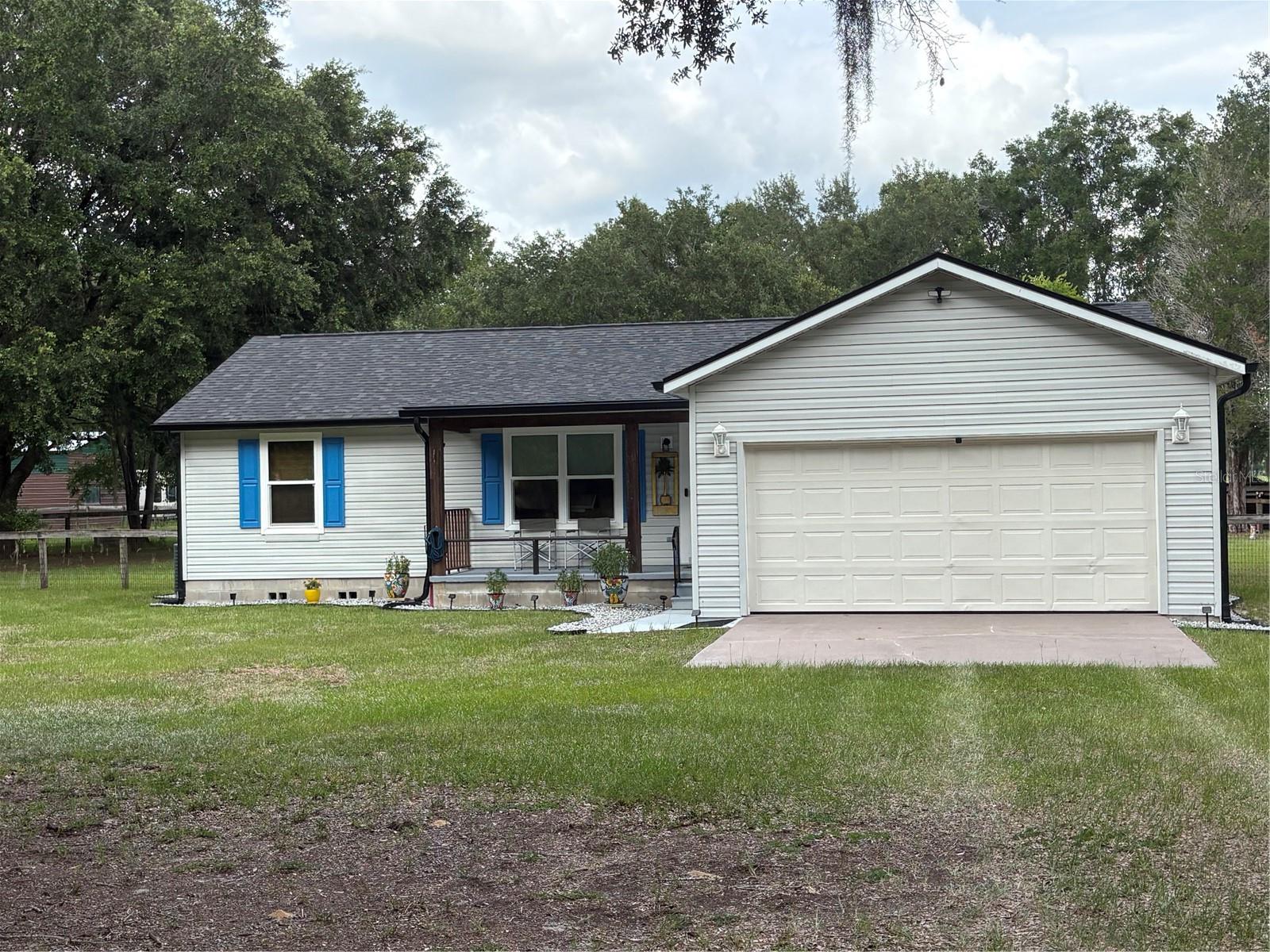Don't miss the opportunity to own this meticulously maintained 3-bedroom, 2-bath split-floor plan home, ideally situated on nearly 2 acres in a peaceful setting. Zoned A-1, this exceptional property offers the perfect blend of country living with the convenience of nearby shopping, medical facilities, and The Villages just minutes away.

Originally designed as the owners' forever home, no expense was spared in the extensive upgrades throughout. The property is fully fenced with a combination of three-board and top-board no-climb fencing, making it ideal for horses, pets, or anyone seeking privacy, security and peace of mind.

Step inside to discover a bright, open floor plan featuring soaring vaulted ceilings, new luxury flooring throughout, elegant 5½-inch baseboards, fresh interior paint, and a spacious screened rear porch—perfect for relaxing and enjoying Florida's year-round sunshine.

The stunning, brand-new kitchen is the heart of the home, showcasing beautiful quartz countertops, all-new cabinetry, brand-new stainless steel appliances, and a convenient coffee bar that's perfect for morning routines or entertaining family and friends.

Both bathrooms have been beautifully updated with quartz countertops, while additional improvements include new ceiling fans, double-pane windows, window treatments, gutters, and numerous other upgrades throughout the home.

Major improvements provide peace of mind, including a new roof installed in November 2023 and a transferable termite bond.

Whether you're entertaining guests, enjoying quiet evenings on the screened porch, or simply appreciating the serenity of your private acreage, this move-in-ready home offers the perfect combination of comfort, style, and functionality. With too many upgrades to list, this is truly a property you must see to appreciate.