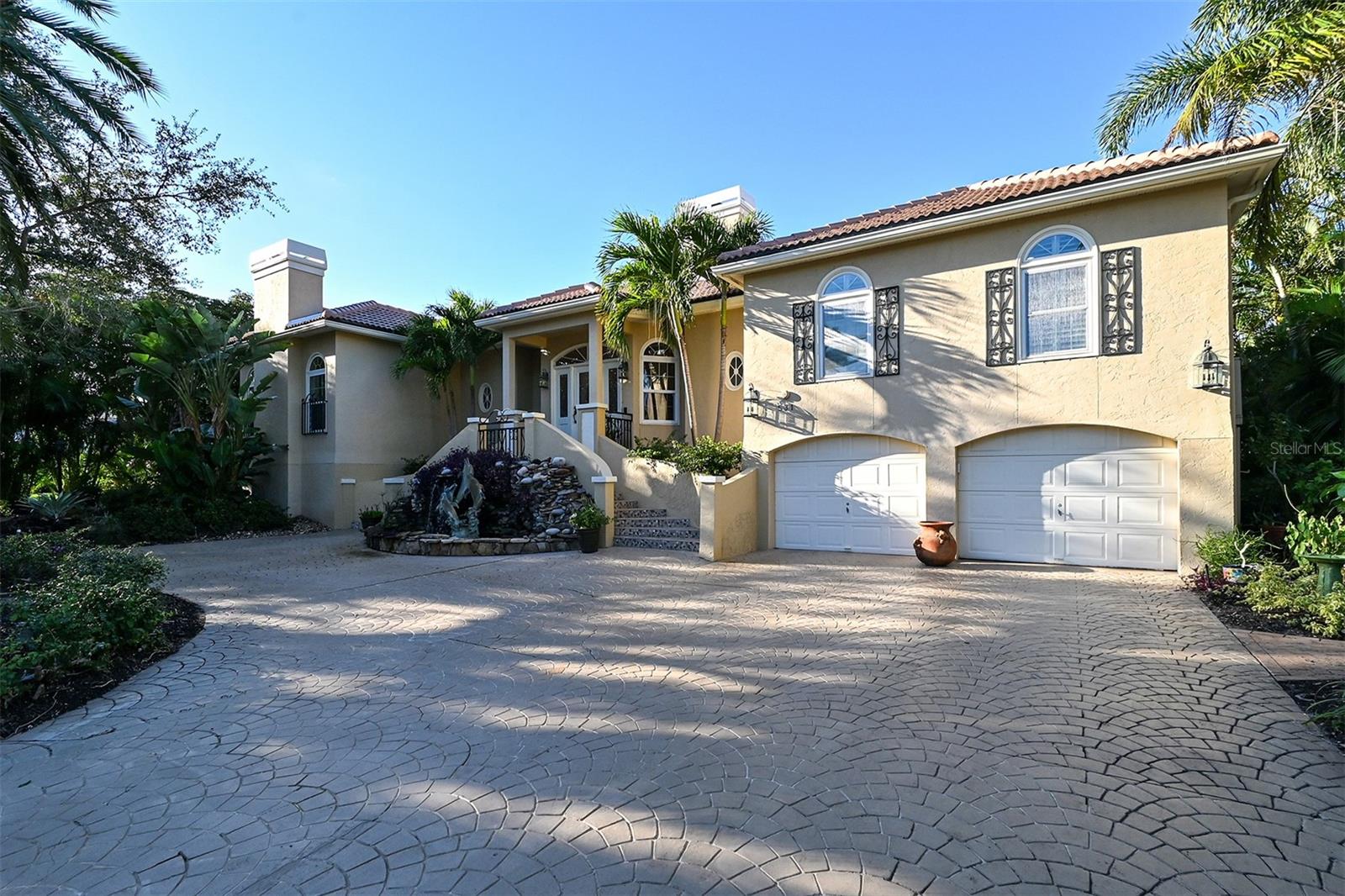 Welcome to your slice of Paradise! Nestled behind the secure Longboat Key Club Gates in Bay Isles, lies this exquisite custom home in the coveted waterfront community of THE HARBOR. Boasting a blend of timeless elegance and modern comfort, this residence underwent major renovations in 2003, with additional updates in 2023 including a new roof.

Step inside and be greeted by an elongated foyer adorned with luxurious marble flooring, leading seamlessly into the expansive great room offering breathtaking panoramic water views. The kitchen is a chef's delight, featuring an abundance of wood cabinetry, a breakfast bar, and top-of-the-line stainless steel appliances, complemented by an informal dining area.

With its open floor plan, high ceilings, and walls of glass French doors opening to the expansive covered deck, this home is an entertainer's dream. Relax by the gas fireplace or mingle with guests while enjoying the serene waterfront ambiance. The oversized formal living room and formal dining room, complete with a natural gas fireplace, provide the perfect backdrop for intimate family gatherings or elegant dinner parties.

Retreat to the primary suite through double doors and immerse yourself in luxury, with sweeping water views of the Harbor and a private fireplace. Pamper yourself in the spa-like bath, complete with two walk-in closets. Adjacent to the primary suite is a glass-encased office offering tranquil pool and harbor views. Additional living spaces include a den and a second bedroom suite on one end of the home, while a spacious third bedroom suite awaits on the opposite side.

Boasting deep water access and quick entry to Sarasota Bay, this community is a boater's paradise. The private dock at this home accommodates both large and small vessels, complete with electric and water hookups, a boat lift for a medium-sized boat, and ample dockage for larger vessels.

Conveniently located near the Longboat Key Club's golf and tennis pro shops, the Publix shopping plaza, and the Bay Isles Beach Club on the Gulf, where membership is included with your purchase, this home offers the epitome of luxury coastal living. Don't miss your chance to experience waterfront living at its finest in this exclusive Longboat Key retreat. Schedule your private showing today and make this paradise your own. Bedroom Closet Type: Walk-in Closet (Primary Bedroom).