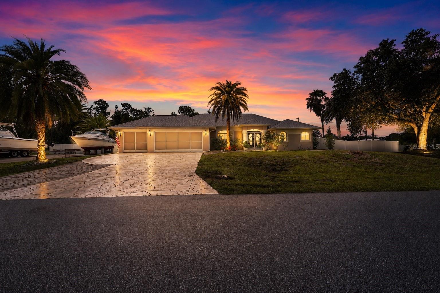 Room for the boat, the trucks, and the recreational vehicle? Absolutely—this custom-built three-bedroom, three-bath home sits on over an acre in the heart of Port Charlotte, and it has space to spare for every toy you own.

Pride of ownership shows in every corner. A smart split floor plan pairs tile in the main living areas with cozy carpeting in the bedrooms, while stainless appliances and solid stone counters lend the kitchen and baths a polished edge. Enjoy casual mornings in the eat-in kitchen, then host something grander in the formal dining room. The oversized primary suite indulges with dual closets and a private office or den tucked just off the retreat.

Outside is where this property truly earns its keep. A covered lanai frames a beach-entry custom pool and spa, complete with a separate full bath for splashy afternoons. The fenced, double-lot backyard hides a private paradise: an outdoor grill, a covered tiki area, and a fire pit made for lingering summer nights. Add a second driveway with fifty-amp service for your recreational vehicle, a conveying storage shed, and mature landscaping for privacy.

Practical peace of mind comes standard—no flood insurance, no association fees, a 2022 roof, and no major storm damage.

Centennial Park, ALDI, and Port Charlotte High School sit minutes away, with Boca Grande's beaches just twenty minutes out. This one deserves an in-person look—schedule your showing today.