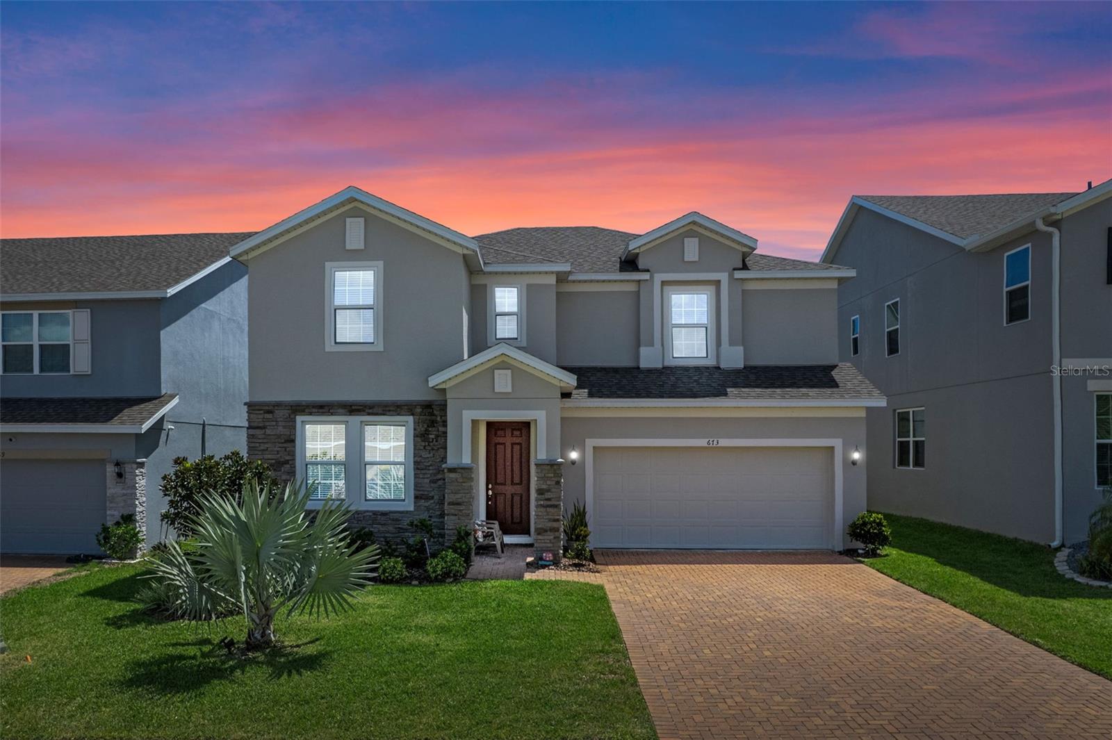 Welcome to this stunning 5-bedroom, 3.5-bathroom home in the highly sought-after Ardmore Reserve community! Nestled in the picturesque rolling hills of Minneola, this prime location is approximately 30 miles west of Orlando, just 35 minutes from Orlando International Airport, about 40 minutes from Orlando's theme parks (Disney, Universal, SeaWorld), approximately 1.5 hours from Tampa, and only 2 miles from the Florida Turnpike, providing convenient access to both Orlando and Tampa. Built in 2022, this contemporary two-story home offers over 2,500 square feet of thoughtfully designed living space. The open-concept floor plan features a spacious great room and café, seamlessly flowing into a chef-inspired kitchen equipped with a double oven, countertop GAS stove, elegant backsplash, 42-inch cabinets with crown molding, Level 4 quartz countertops, and a large center island—perfect for entertaining. The main floor includes one bedroom with a full bathroom ideal for guests or multigenerational living, plus a separate half bath for added privacy. Upstairs, you'll find four additional bedrooms—including a luxurious primary suite—as well as a versatile loft and a convenient laundry room. The primary bathroom is a true retreat, featuring frameless glass shower doors, dual shower heads including a rainfall option, and a high-end Kohler electronic shower control system. Step outside to a covered lanai that overlooks a beautifully maintained backyard, perfect for relaxing or entertaining. Additional features include a two-car garage, energy-efficient systems, walk-in closets, Level 4 ceramic tile throughout main and wet areas, and plush carpet in all bedrooms.Home features, a drop zone, permable pavers in driveway, veneer stack stone, oversized pantry . Enjoy exclusive access to community amenities such as a resort-style pool, playground, and scenic walking trails. Conveniently located near top-rated schools, shopping, major highways, the upcoming Crooked Can Brewery, the new AdventHealth hospital, and the popular Clermont Chain of Lakes—this home offers the perfect blend of style, comfort, and location.