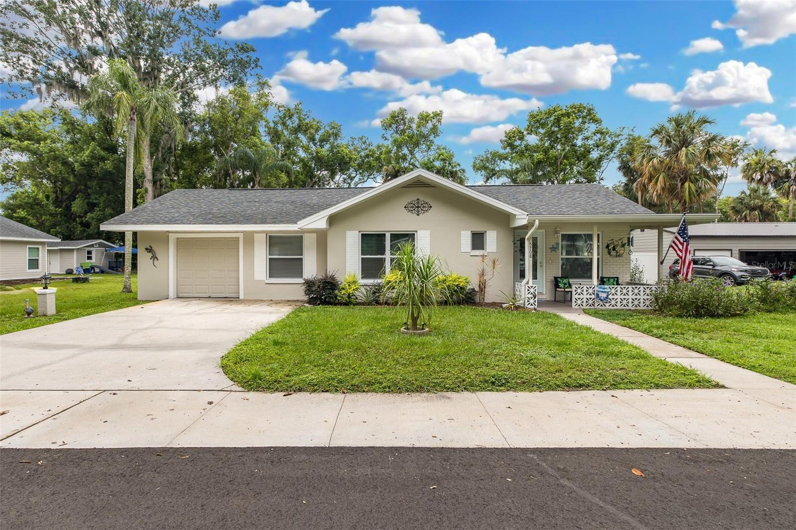 THE MOST CHARMING HOME IN THE DOWNTOWN NEW PORT RICHEY AREA. EXTREMELY HARD FIND! ZONED R2. ALLOWS DENSITY HOUSING(ADDITIONAL STRUCTURES). The epitome of the meaning of HOME SWEET HOME.  This 2/2/1 is an absolute gem. NO HOA. NO RENTAL RESTRICTIONS. THIS HOME HAS A PARCEL OF LAND ON THE COTEE RIVER THAT IS IN YOUR DEED. IT ALLOWS YOU TO ENJOY FISHING, RELAXATION OR PICNICKING, BOAT PARADES AT YOUR LEISURE. RIPARIAN RIGHTS. Everything new.  IMPACT WINDOWS! Kitchen, baths, roof, AC , flooring, paint, INSTAHOT WATER and so much more. Recently added Utility shed with car port area. The charm gleams in many areas. Woodworking, cozy feel, and the style of the home brings a wonderful feeling. LOCATION is one block from Grand Blvd.  Walking path to SIMS PARK. Golf cart friendly. YOU HAVE A GREEN THUMB? Well this home has its own GREEN HOUSE and over a 1/4 of an acre to grow things on! MAKE THIS ONE YOUR NEXT SHOWING!