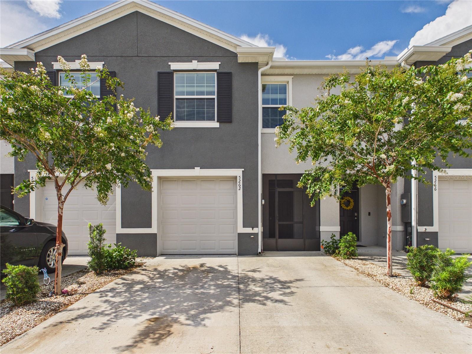 Welcome to this beautifully maintained two-story townhome, built with durable all-concrete block construction, offers an inviting open-concept floor plan perfect for everyday living and entertaining. The first floor features a spacious living room with a large TV, an open kitchen and dining area, a convenient powder room, and a covered lanai - perfect for relaxing or enjoying your coffee. A portable TV located in the storage area is also included. The home includes all appliances, including a refrigerator, dishwasher, range, microwave, washer, and dryer. Upstairs, there is a spacious primary bedroom with large TV, two additional guest bedrooms, two full bathrooms, and a conveniently located laundry area. Thoughtful upgrades throughout the home include motion-sensor lighting in the closets, a touchless motion-sensor kitchen faucet, and fiber-optic internet availability for fast, reliable connectivity. The HOA includes access to a community pool, providing the perfect place to relax and enjoy the Florida lifestyle. Don't miss the opportunity - schedule your private showing today and come see this beautiful townhouse for yourself.
