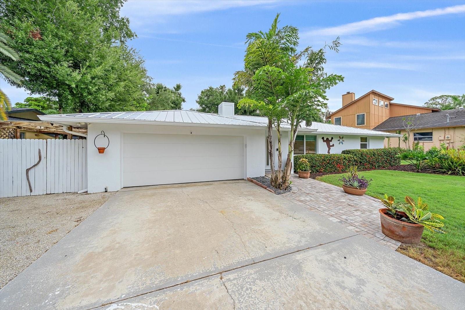 Virtually Staged. There are places in the world where life just feels lighter. 4271 Lago Way is one of them.

From the moment you enter, the view stops you in your tracks — a sweeping sightline through the home to a lush, verdant lawn that slopes gently down to a private dock on the lake. This is not just a house. This is a lifestyle.

Beautifully renovated and move-in ready, this lakefront residence is nestled in the established Lake Sarasota neighborhood — with no HOA. The seller is a luxury custom home builder, and this home bears the mark of that expertise — every upgrade selected and executed with the discernment of someone who builds at the highest level. Three bedrooms, includes a primary bedroom with its own private bathroom, plus a second full bathroom serving the remaining two bedrooms. The crisp kitchen features solid wood cabinetry, subway tile, stainless steel appliances, a wall-mounted stainless rack for cookware and utensils, and a pot filler — everything a serious cook could want. Adjacent to the dining area, a wet bar with sink, a teal retro designer refrigerator, and custom cabinetry makes entertaining as effortless as the setting. The wood burning fireplace anchors the family room with warmth, while the interior laundry room, two-car garage with Tesla charger, additional gravel drive suitable for a boat, trailer, or recreational vehicle, and impact windows and doors throughout add everyday ease — all wrapped in the peace of mind that comes with a new roof (2025) and a security system with cameras that convey.

Head outside through the dining room and discover a generous concrete terrace, ideal for al fresco dining beneath an open sky. The grounds are fully fenced on both sides, creating a private setting — with the lake as your only true neighbor. A storage shed keeps everything tidy and close at hand. Gather at the dock as turtles sun on the surface, fish glide below, and birds work the shallows — light the fire pit and gather with friends, loved ones, or whoever makes the moment complete, as the water goes still and the stars come out.

The patio and lawn invite everything else — afternoon barbecues, a game of horseshoes, lazy afternoons in a hammock, picnics in the grass, a vegetable garden already flourishing in the ground. Just around the corner, Lakeview Park offers a kayak launch, pétanque — the classic French lawn game played with steel boules — disc golf, a playground, and a paw park for four-legged companions — and A-rated Lakeview Elementary is equally close. And when the world calls, everything is within easy reach — Siesta Key Beach, Nokomis Beach, Marina Jack's, UTC Mall, and Trader Joe's all just a short drive away.

Some houses are just houses. This one is a home — solid, welcoming, and just as happy to see you as you are to see it.

Come experience it for yourself.