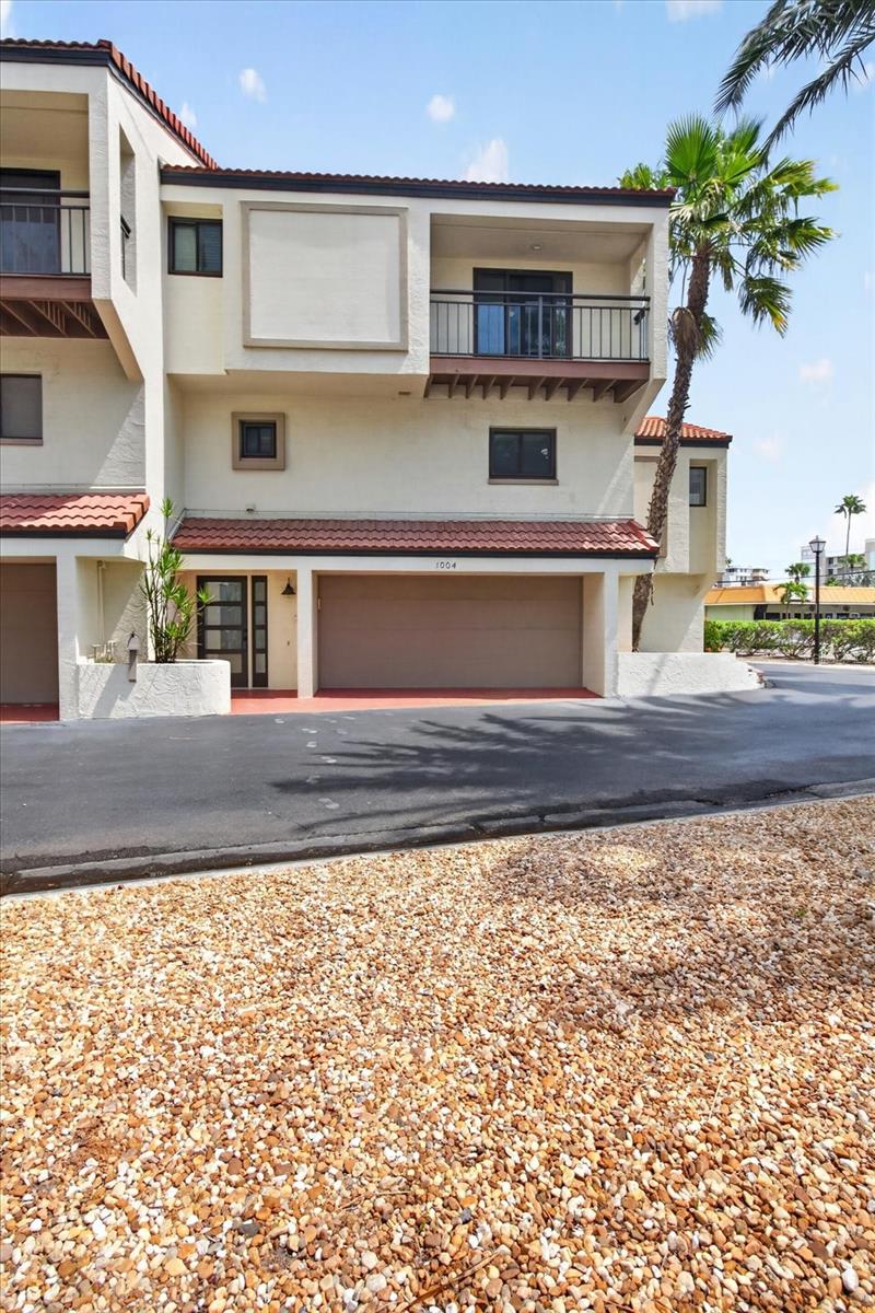 Come enjoy the Florida Lifestyle you deserve in this elegantly designed townhome on Island Estates.  Beautifully decorated Entryway invites you to the second floor that features a living room, dining area, kitchen, den/bonus room, laundry room, & half bath.  Gorgeous porcelain flooring showcases the second floor living area.  Enjoy relaxing in the living room in front of the electric fireplace, or enjoy grilling out on the balcony deck.  The kitchen features imported Italian Cucina glass front cabinets with 2 slide out pantries, quartz counter tops, Gaggeneau in-counter steamer, stainless steel refrigerator & Samsung split oven range (2015), & porcelain tile, & Breakfast Bar.  The laundry room is off the kitchen.  The powder room has stunning blue glass tile & Antonio Lupi molded sink. The den has cork flooring, crown molding & a balcony. Go up the newer spiral staircase to the third floor features the master bedroom with oak flooring, crown molding, his & her closets, a window seat & balcony. The master bath has walk in shower and dual vanity quartz countertop. The third bedroom features ash wood flooring & built-in workstation & yes another balcony that is shared with the 2nd bedroom. The bath has Robern slide-up/lighted cabinets, Agape sink & recessed lighting over the tub. The bathrooms are European designed, featuring German Duravit toilets & Hansgrohe fixtures/faucets. Other upgrades are solid wood doors & water heater in 2015, Trane a/c & air handler (2024), water conditioner/purifier, & newer light fixtures. Miami code rated garage door (2015) & windows installed in 2011. 2 car garage with a 10x25 workshop. deep water boat slips (as available) & 2 community pools. The building exterior was painted & driveways resurfaced in 2016.  Roofs were replaced about 7 years ago.  Price includes all furniture as displayed.  Come enjoy Clearwater Beach, famous for its
sugar sand beaches, vibrant atmosphere, nightlife, retaurants & gorgeous sunsets!