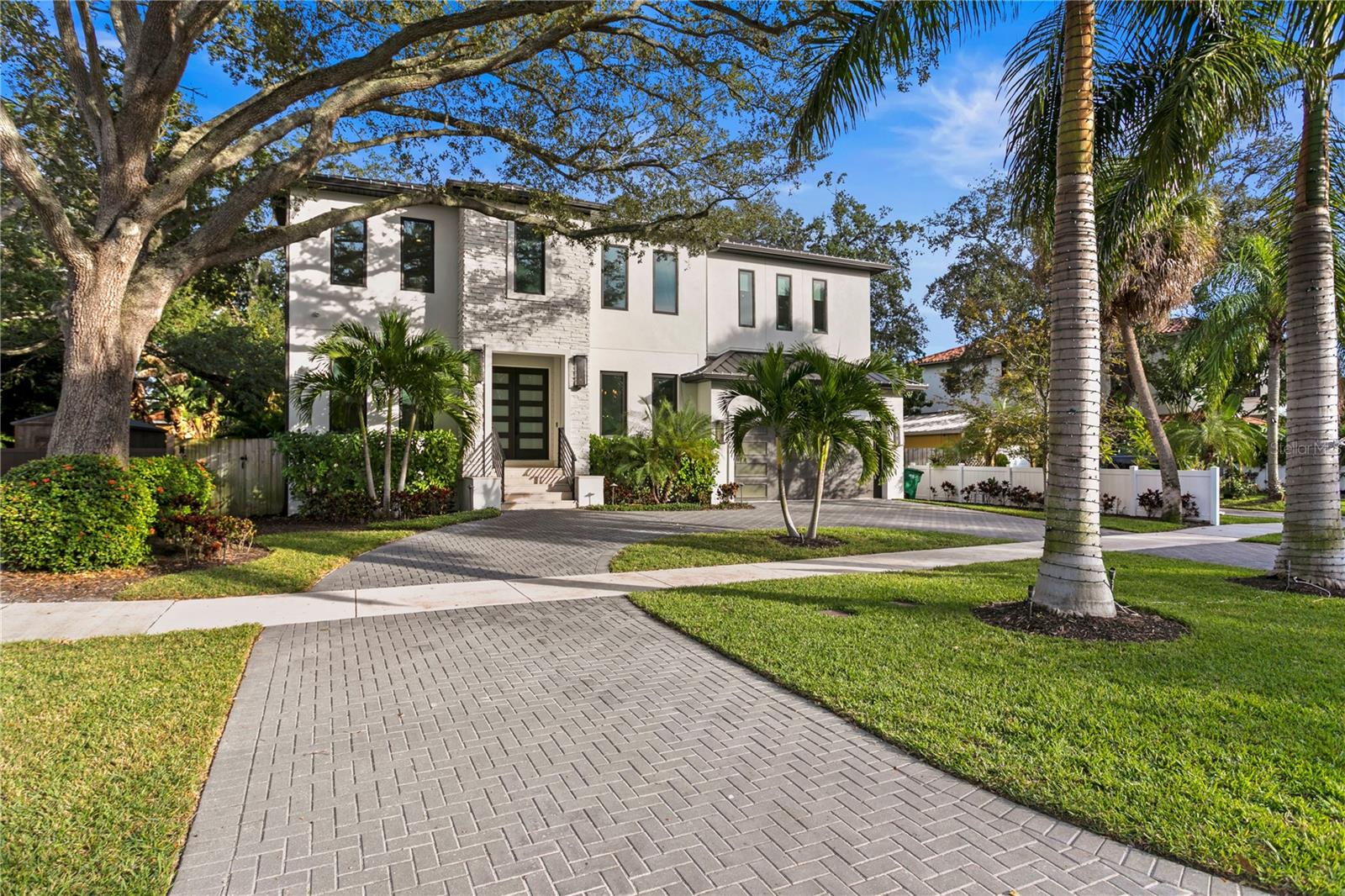 GREAT OPPORTUNITY to be in a newer home on Davis Islands.  This 5 bedroom, 4 bathroom luxury pool home on Davis Islands was custom built in 2019 and features an oversized 2 car garage, gourmet kitchen, and 4,455 sq ft of fantastic living space! Meticulously designed, the lush landscaping of the exterior perfectly complements the contemporary build. Through the double front doors, guests are greeted through a foyer flanked by a bright office and formal dining room. Traveling further into the home, one can't miss the large sliding glass doors in the family room that can fully open to the impressive outdoor entertaining area. This allows for seamless movement from the gourmet kitchen, informal dining space, and spacious family room with gas fireplace. The large open concept kitchen features real wood cabinets, quartz countertops, contemporary pendant lighting and an extensive waterfall island perfect for additional seating or cooking for a household. The kitchen is also open to the informal dining room and has access to the walk-in pantry. The pantry is just beyond the mudroom with thoughtfully laid out cabinets and counter space for storage. It can also directly be accessed through the garage which is convenient for off loading groceries. The first floor also features a guest room with bathroom access. Up to the second floor lies the master suite. The space is large but impressively warm with the combination of light wood floors, tall tray ceiling, and contemporary lighting. The master bath features double vanities, a soaker tub, and a shower with a rain faucet system. A walk-in closet also includes built-in shelving and clothing racks. Three additional bedrooms, two additional bathrooms, a game room, and a laundry room share the second floor space. Every detail of this home was carefully thought out from the gorgeous wood floors, to the tall tray ceilings, statement walls, lighting fixtures, and automated blinds! Enjoy all sunny Florida has to offer without leaving your home! The back porch boasts tongue and groove ceilings plus an outdoor kitchen with grill and built-in mini fridge. The porch overlooks the designer pool and spa surrounded by travertine pavers and lush landscaping. This space is perfect for spending a summer day outdoors or entertaining guests! Located on desirable Davis Islands, within minutes from downtown Tampa! Given all this home has to offer, it won't last long. Call today to set up your private showing!