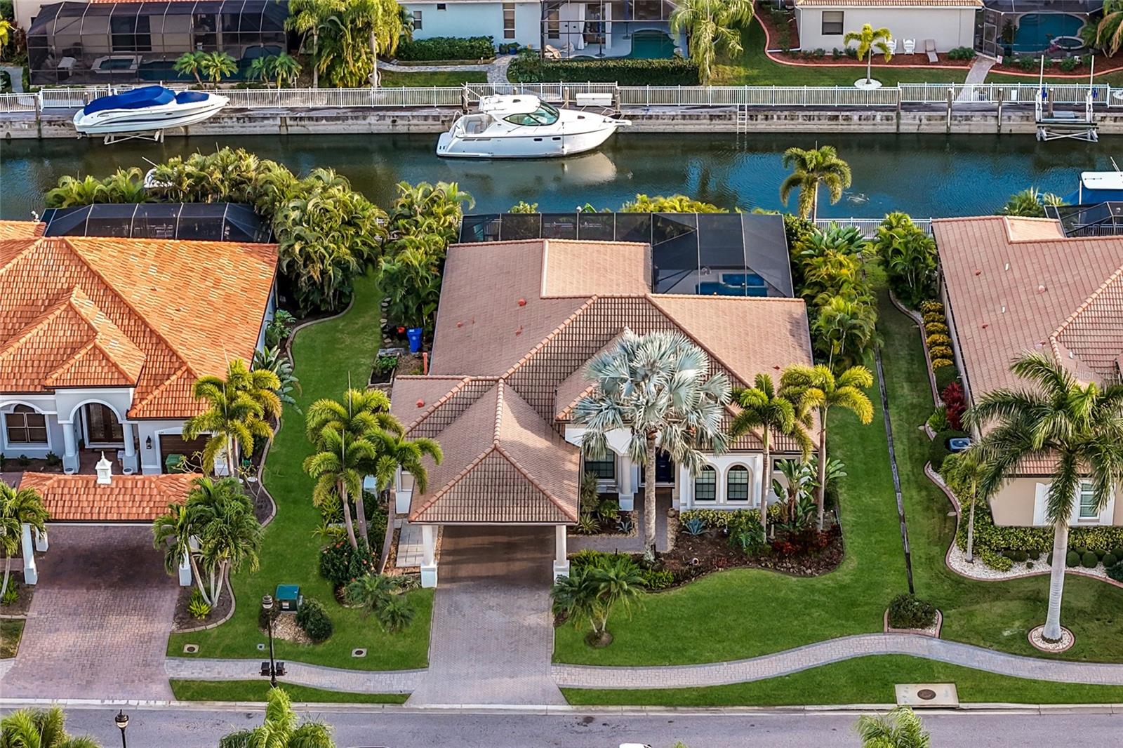 This is the BEST opportunity to reside behind the gates of Harbour Walk for the LOWEST PRICE POINT! Welcome to Harbour Walk at the Inlets, a GATED BOATING COMMUNITY designed with both comfort and peace of mind. The home is equipped with a WHOLE-HOUSE GENERATOR AND HURRICANE SHUTTERS on all windows and doors, designed for ease-of-use and added storm protection. These features make it simpler to secure the home and travel with greater confidence. This single-level home features a bright, inviting layout with high ceilings and sliding glass doors that create a seamless connection between indoor and outdoor living spaces. The floorplan includes FOUR bedrooms PLUS a den/office, and a spacious two-and-a-half-car garage with lots of STORAGE options, offering flexibility for everyday living. Set among mature landscaping for added privacy, the home’s outdoor area includes a screened lanai with extended covered space, a full OUTDOOR KITCHEN, and a POOL AND SPA with the coveted SOUTHERN EXPOSURE. It is a practical and enjoyable setting for relaxing or spending time with family and friends. For boating enthusiasts, the property offers a private dock on a freshwater canal with DIRECT ACCESS TO THE GULF, making it easy to navigate toward Tampa Bay and beyond. The freshwater canal location provides an added level of protection, and the community is positioned to support a more secure boating environment. Conveniently located near shopping, dining, and daily essentials, the property also provides straightforward access to nearby destinations such as Anna Maria Island, Longboat Key, and Siesta Key, along with 3 major airports and I-75 is only 2 miles away to take you to any destination. Harbour Walk offers a range of amenities including a kayak launch, fishing dock, playground, tennis courts, and walking trails, all within a private gated setting. With NO CDD FEES and CABLE AND INTERNET INCLUDED, this home presents a well-rounded opportunity for those seeking a waterfront lifestyle with an emphasis on practicality, safety, and convenience.