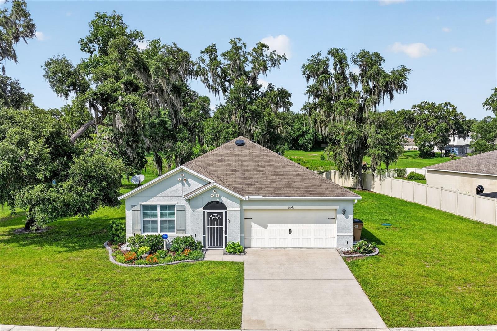 Welcome to 10521 Bronze Leaf Court, a beautifully upgraded and meticulously maintained home located in the peaceful community of Bentwood in Leesburg. Situated on an oversized .36-acre homesite with serene nature views and no rear neighbors, this property offers the perfect combination of privacy, comfort, and Florida living.  

This popular DR Horton Aria floor plan features 3 bedrooms, 2 bathrooms, an open-concept layout, abundant natural light, and numerous owner-added upgrades throughout. The spacious kitchen has been enhanced with upgraded stainless steel appliances, additional cabinetry, upgraded sink and faucet, pantry shelving, and beautiful pendant lighting with dimmers over the island. Laminate flooring adds warmth and style to the living and dining areas, while the primary bedroom features upgraded carpeting.

Enjoy the Florida lifestyle year-round from the extended and screened lanai overlooking the expansive backyard with mature landscaping and nature views. Additional thoughtful improvements include a screened front entry, gutters over the garage, solar attic exhaust fan, Blink security cameras, SimpliSafe monitored alarm system, indoor/outdoor temperature station, and upgraded storage solutions throughout the home including garage shelving, tool racks, work bench, laundry room cabinetry, and custom closet shelving.

Bentwood offers oversized homesites, sidewalks, a playground, and a peaceful setting while remaining conveniently close to shopping, dining, entertainment, Downtown Leesburg, Downtown Tavares, and major roadways. This move-in ready home combines functionality, privacy, and value with upgrades already completed for the next owner. Schedule your private showing today before this exceptional property is gone!