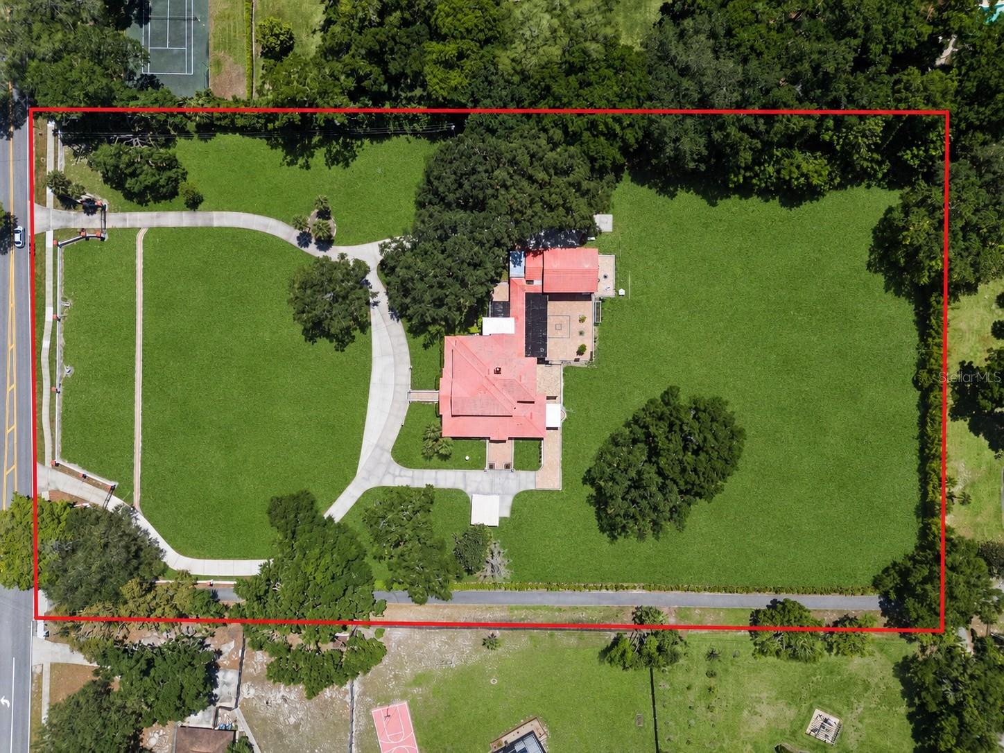One or more photo(s) has been virtually staged. Owner Financing Options Available...Call For Details.  Looking for a private, multi-acre estate with the flexibility to expand, entertain, or create a true multi-generational compound? Welcome to the prestigious Markham Woods Corridor. Set on a cleared, high-and-dry 5+ acre homesite with no HOA restrictions, this property offers rare freedom and tranquility, feeling like your own private park complete with gorgeous mature oak trees, lush living privacy walls, and a dual-gated entrance. 

The beautifully renovated main residence spans nearly 5,600 square feet and has been meticulously updated within the last year to offer ultimate peace of mind. Major recent upgrades include completely brand-new plumbing throughout the entire home, four new HVAC units, and fully modernized bathrooms featuring pristine new tile, hardware, lighting, and vanities.

Luxurious Main Residence Features include a Flexible Layout with up to 8 bedrooms (including 5 en-suites) and 8 bathrooms. Three spacious primary suites feature private baths and walk-in closets, plus a separate in-law suite with its own entrance, living area, kitchenette, and full bath.  The Gourmet Kitchen is The heart of the home and boasts granite countertops, a massive center island, and premium appliances, including a Samsung 3-door refrigerator, Samsung dishwasher, and an Electrolux Icon dual oven/freezer stack.  With Smart Home Technology; Enjoy automated luxury blinds on the main floor, smart-controlled exterior fountains, and customizable, color-changing boundary wall lighting.

With Unrivaled Entertainment & Outdoor Living features include a separate Ballroom / Theater with a $30,000 state-of-the-art automated LED lighting system that transforms this exceptional space. Featuring smart-controlled curtains, an LG mini-beam short-throw projector, a dedicated stage, and eight surrounding screens, it is perfect for hosting large-scale events, weddings, yoga retreats, or epic movie nights.  Outdoor Entertaining doesn't get any better than this. Step out onto +/- 4,000 square feet of luxury brick pavers. The outdoor summer kitchen area is a chef's dream, featuring a commercial Vulcan convection oven complete with a full-sized pizza stone for authentic, restaurant-quality entertaining.  *BONUS*- Exclusive Custom Pool Opportunity: While the expansive grounds offer a blank canvas, the seller—a commercial pool contractor—is offering an exclusive buyer incentive to build a custom pool to your exact specifications at their direct cost, allowing you to design your dream oasis without the retail markup!

The Detached Guest Quarters is Connected to the main home by a beautiful red-tiled covered breezeway.  The massive two-story detached building offers a fully climate-controlled space. Upstairs features a 3-bedroom, 1-bath apartment with a spacious lounge. Downstairs boasts a beautiful stainless steel kitchen, a storage room, and a garage—ideal for guests, staff, or incredible income-producing potential.

Zoned for horses and offering ample space for boats, RVs, and recreational vehicles, this estate is perfectly suited for a variety of uses. Conveniently located near Heathrow shopping, top-rated schools, area golf courses, and just 30 minutes from Orlando and the East Coast beaches. This is more than a home; it’s an investment in endless possibilities.  Properties with this level of versatility, luxury, and land in this corridor rarely hit the market, and they never stay long.  Call Today!