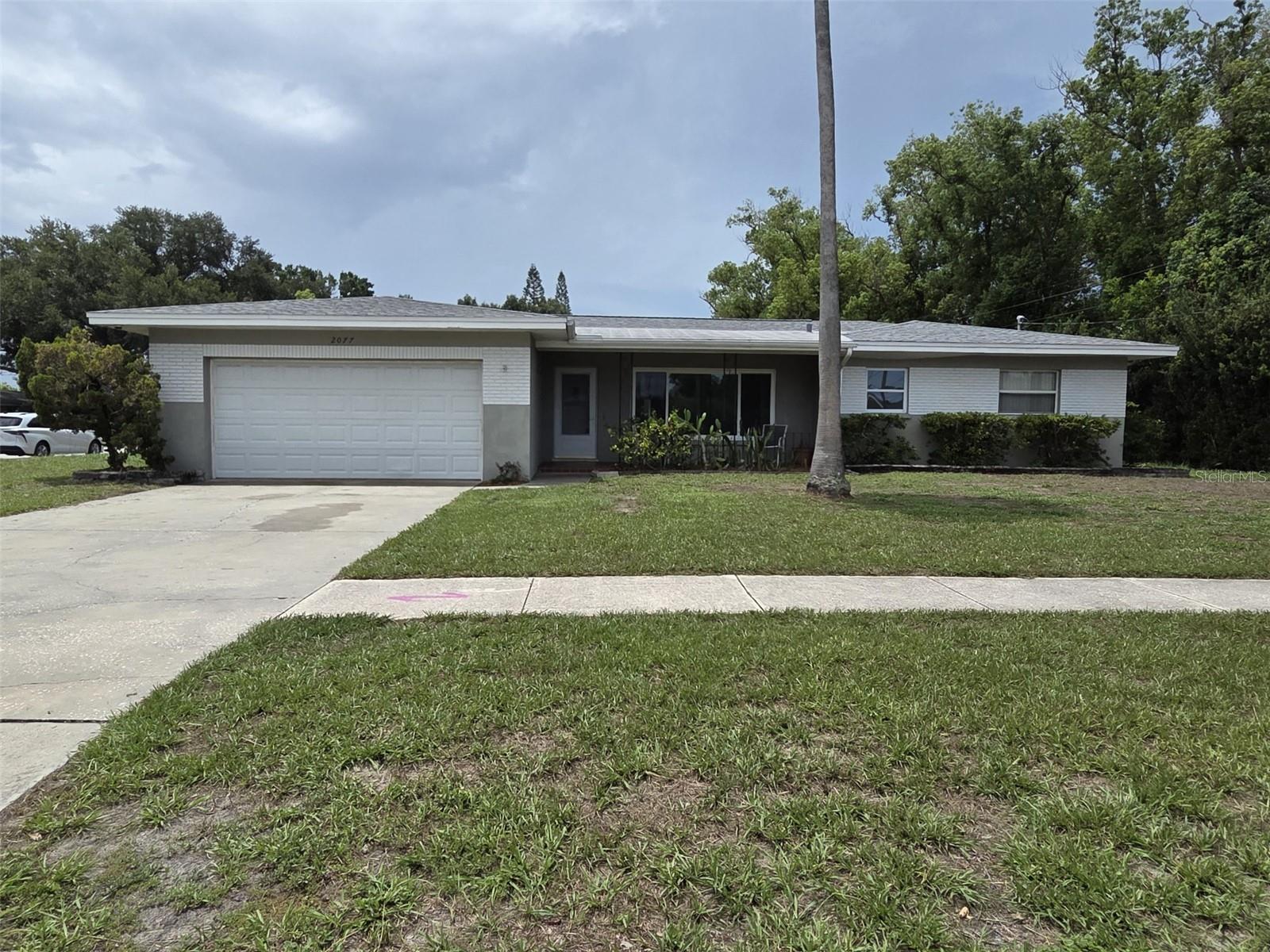This charming single-family home located at 2077 Druid Rd in Clearwater, FL offers a perfect blend of vintage charm and modern convenience. Built in 1957, this well-maintained property boasts a spacious interior with a total of 2 bathrooms and no half bathrooms. With a finished area of 1,374 square feet, there is plenty of room to relax and entertain.

Situated on a generous lot size of 9,178 square feet, this home provides ample outdoor space for gardening, recreation, or simply enjoying the beautiful Florida weather. The lush landscaping adds to the curb appeal and creates a welcoming atmosphere.

The interior of the home features a cozy living room, a functional kitchen with updated appliances, and comfortable bedrooms. The bathrooms are well-appointed with one bathroom having a tub, shower, vanity, toilet and large linen closet. The ensuite bathroom includes an updated shower, toilet and vanity. The large windows throughout the home allow natural light to flood the space, creating a warm and inviting ambiance.

The property's location in Clearwater, FL offers easy access to a variety of amenities and attractions. Whether you want to enjoy a day at the beach, explore the local shops and restaurants, or take in the natural beauty of the area, there is something for everyone nearby.

Overall, 2077 Druid Rd is the perfect place to call home for those seeking a peaceful retreat with a touch of nostalgia. Don't miss the opportunity to make this lovely property your own and start creating lasting memories in this wonderful community.

This home is located in a highly sought-after neighborhood due to its central Pinellas location. The house is across the street from the Druid Road bike trail that leads to Clearwater beach which is only 5 miles away and the Duke Energy trail heading east. The home is zoned for Plumb Elementary, Oak Grove Middle, and Clearwater High Schools. It is a parent's dream that their child will never have to ride a bus to school. It is near shopping, downtown Clearwater and Tampa International Airport yet sits in a quiet neighborhood where many families have resided for decades without moving.

The interior boasts an open layout inclusive of a dining room, kitchen and living rooms all with porcelain tile floors and a custom tumbled marble inlay in the living room that looks like an area rug. The three bedrooms have carpet flooring. A bright and cheery bonus room may be used as an office, den or reading room. A screened-in room with large roll-down shades is situated off the dining room provides an outdoor experience without the bugs. The attached two-car garage has an indoor laundry area and extra space for storage or an extra refrigerator. It's a must see!

One bedroom is 12 X 13 and the other two are 14 X 12. The house has central heat and air, but if you open up the N and S windows, it has a nice cross-breeze that cools it off well.