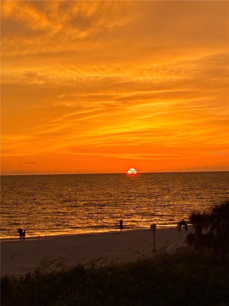 Exclusive waterfront living in Bradenton Beach! On the pristine shores of Anna Maria Island, this exquisite condominium offers an unparalleled blend of luxury, privacy and breathtaking beach and sunset views. In an exclusive 36-residence community, this intimate complex is positioned between a sparkling heated pool with a spa and the sugary sands of the beach. Across the street, enjoy direct beach access or the Tiki Hut for a cool beverage. Designed for tranquility and convenience, this spacious two-bedroom, two-and-a-half-bath retreat boasts expansive windows that flood the space with natural light, accentuating the sweeping coastal vistas. Recently designed with luxury vinyl flooring, an updated kitchen and fresh paint, this furnished, move-in-ready home provides impact hurricane-rated windows, high vaulted ceilings, a washer and dryer inside the unit and a split bedroom floor plan, with each bedroom offering an ensuite bath. Culinary enthusiasts can enjoy the gorgeous kitchen, with quartz counters, soft-close drawers and cabinets and stainless steel appliances. The unit is outfitted with the primary bedroom on the first floor plus a half bath just off the main living area, offering convenient access for you and your guest, and a second-floor loft-style guest bedroom or office. This pet-friendly community provides a bayfront heated community pool and spa with an upgraded pool deck, bathhouse, boat and fishing dock, kayak and paddleboard storage and social gatherings. Have peace of mind knowing the association reserves are fully funded and had a new roof installed in 2025, updated the elevators and added beautiful landscaping throughout. With a 30-day minimum rental policy up to four times per year, the community maintains an exclusive, low-turnover atmosphere, ideal for those seeking a more serene coastal escape. Covered parking under the building adds convenience with two parking spots, plus a building elevator, and the community pool and spa provide a picturesque setting for outdoor gatherings and events. Ideally located, this residence offers effortless access to the charming shops, acclaimed dining and vibrant culture of Bradenton Beach and Anna Maria Island. Experience Gulf view living at its finest, where tranquility, luxury and convenience converge. Schedule your private showing today.