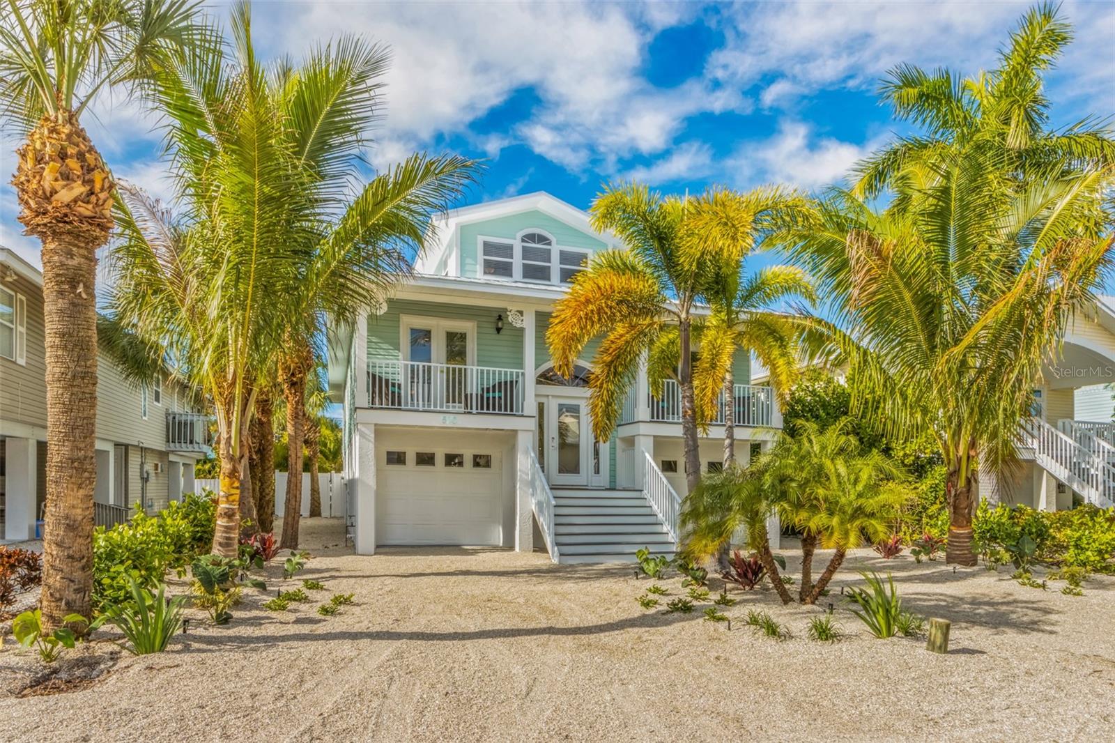 Welcome to Aloha Beaches. This home is a successful active rental in the city of Anna Maria. It started out as a 2-bedroom, 2-bath elevated home with a loft and no pool. However, with the seller’s vision, the home was transformed by Wash Family Construction and Agnelli pools into what you see today. Today it is a gorgeous 4-bedroom 3-bath open floor plan pool home. No part of the home was untouched. Let's start in the new kitchen. It was completely redone with new appliances, cabinets, and countertops. All the original tile and carpeted floors were removed and replaced with luxury vinyl planking. The living room and dining room, once separated by a knee wall, are now wide open. Both bathrooms on the main level were renovated from top to bottom. Upstairs, the loft was expanded and closed to the staircase. It now boasts 2 bedrooms with a Jack and Jill bath between them. Speaking of the staircases, all the interior stairs rails were whimsically redone with custom made boat oars. The garages have been entirely resurfaced with protective epoxy becoming a huge indoor play space on a rainy day. Now, let us go outside. On top of the home is a brand-new metal roof. All the railings in front and back were replaced and the rear lanai porch off the living room and primary bedroom was re-screened. The original stairs to the rear yard were replaced with a spiral staircase, landing on the new pool deck. There you will find a large saltwater pool with a jacuzzi, sun platform and swim-up pool bar with stools. In the rear of the property, overlooking the pool, is a 28x18 foot cabana with a spacious bar, undercounter refrigerator, shaded seating area, and a 75-inch TV on the wall. Make sure to try the whimsical outdoor surfboard hot and cold Shower. You will never need to leave the rear yard paradise if you choose not to. The home is a short stroll to the soon to be re-opened City Pier, the Waterfront Restaurant, and all the other restaurants and shops on Pine Ave. You can catch the free Trolley here to take up and down the island. Soon you also be able to board the new Manatee County Water Taxi when service resumes. It will provide travel to The Bridge St. Pier and Downtown Bradenton. The home is also not a much further walk to the gorgeous beaches of Anna Maria on the Gulf. Here you will find magnificent Australian Pines providing shade though out the day. One thing I did not mention, the home is being sold turn-key furnished and ready to enjoy as your personal home, a second home, or a fabulous rental property with future bookings already in place for 2026 and into 2027.