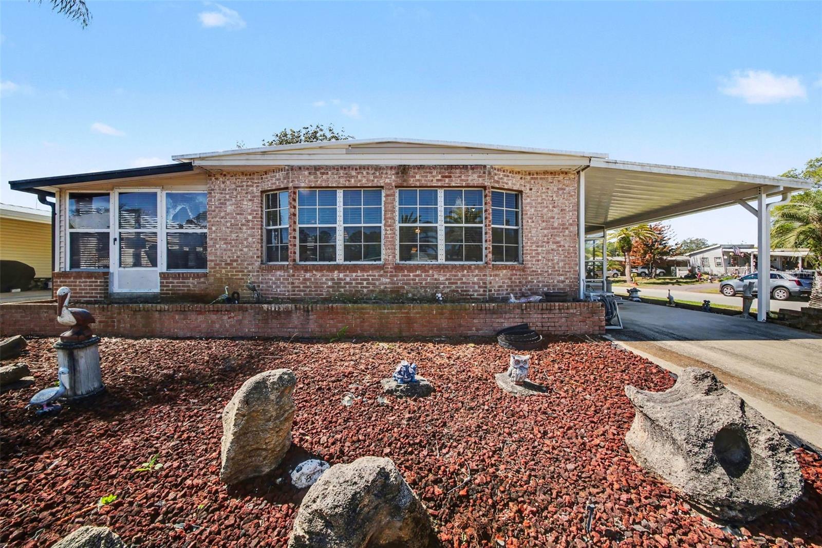 Special Financing Incentive Available – Promotion Expires June 30, 2026! Qualified buyers may be eligible for a conventional loan featuring a 1-0 rate buydown and a lender-paid appraisal through the preferred lender. Buyer qualification and use of the preferred lender are required.

Situated on a desirable corner lot in the sought-after Laurelwood 55+ community, this well-maintained 2-bedroom, 2-bath home offers the added benefit of NO LOT LEASE—YOU OWN THE LAND. Enjoy a voluntary HOA of just $25 a year.

This charming residence features 1,208 square feet of living space plus two Florida rooms, providing flexible options for entertaining, hobbies, or a home office. The front Florida room and carport were completely rebuilt in 2023, enhancing both curb appeal and functionality. The side Florida room opens to the main living area and can be separated with insulated drapes for added privacy and versatility.

The spacious primary suite includes a walk-in closet and private ensuite bath with a step-in shower. The guest bedroom is generously sized and also features a walk-in closet. An updated guest bathroom offers a tub/shower combination.

The bright and inviting kitchen is filled with natural light from a wall of windows and features a breakfast nook, dedicated dining area, and built-in storage. An attached shed houses the washer and dryer while providing additional workspace and storage.

Recent updates include a NEW ROOF (2026), water heater (2024), refrigerator (2024), range (2024), microwave (2024), dishwasher (2024), and a maintained irrigation system (2026). The irrigation system operates on a private well, helping reduce utility costs.

Conveniently located near shopping, dining, healthcare facilities, and major roadways, this property offers both comfort and accessibility.