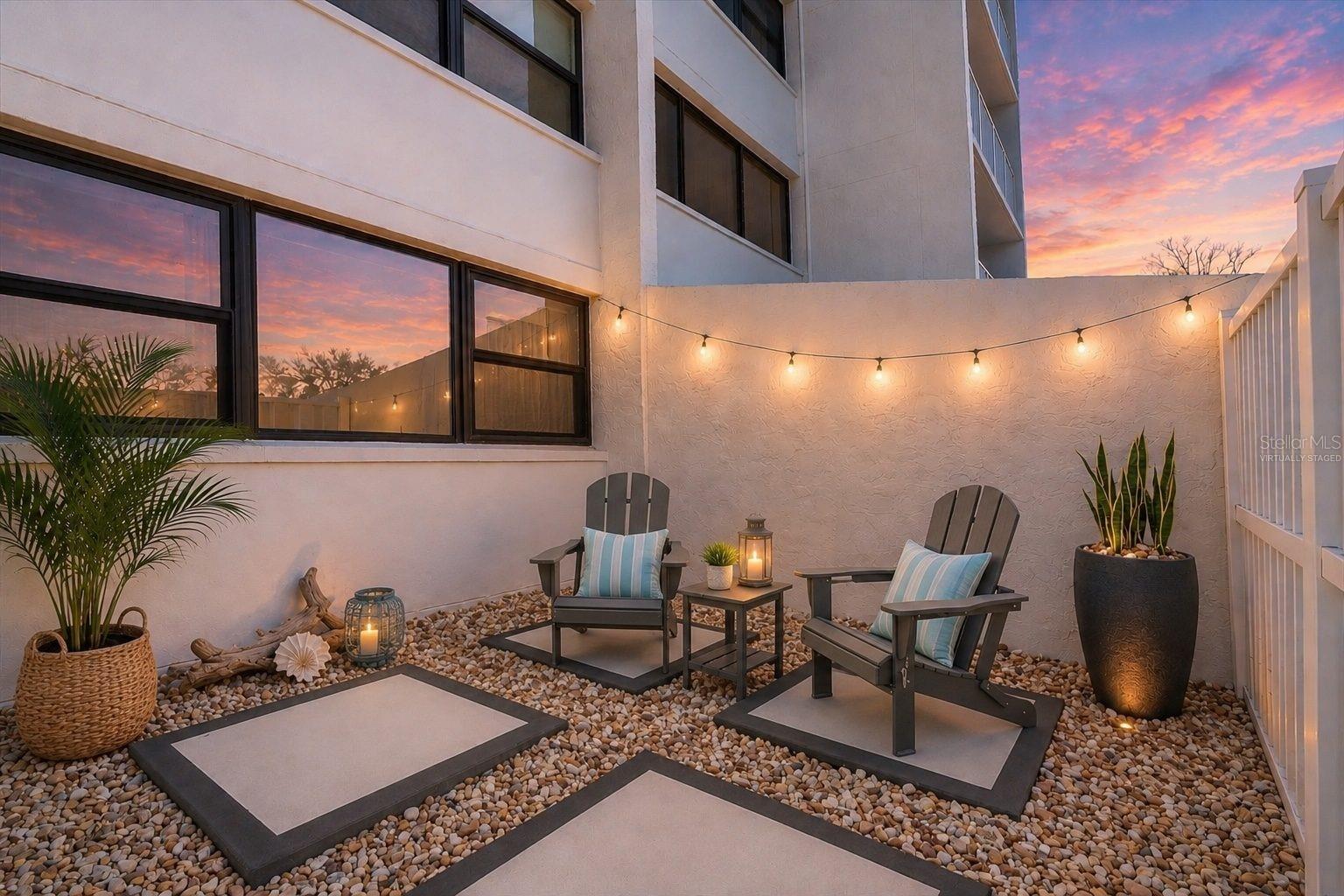 Some photos virtually staged. Experience elevated coastal living in this fully reimagined, turnkey Treasure Island beach-area condo just steps from the Intracoastal Waterway. A rare offering, this residence features an expansive ~500+/- sq. ft. private outdoor retreat with a covered lanai and open-air courtyard, designed with new concrete, coastal river rock, and privacy fencing for a secluded, resort-style setting.

Inside, refined finishes and thoughtful upgrades define the space. The designer kitchen features Level 4 quartz and granite countertops, solid wood cabinetry with soft-close doors and pull-out drawers, a coffered ceiling, and newer Gallery-series appliances. The open living area is enhanced by crown molding and waterproof luxury laminate flooring throughout.

Both bathrooms have been fully renovated with updated cabinetry, tile, fixtures, and finishes. Major system upgrades 2026 include electrical with new panel, updated plumbing, new water heater, HVAC (2022), and hurricane-rated impact windows and sliding glass doors.

The building is undergoing significant improvements, including new interior and exterior paint, updated common areas, hurricane-rated entry doors, and engineered water intrusion protection. Milestone inspection and reserve study completed.

The spacious primary suite offers dual custom closets and an updated en-suite bath. The private outdoor space is ideal for entertaining, al fresco dining, or relaxing in your own coastal retreat.

Ideally located near award-winning Treasure Island Beach, waterfront dining, shopping, and the Treasure Bay Golf & Tennis facility with pickleball and a 9-hole course. Downtown St. Petersburg is a short drive, offering fine dining, museums, marinas, waterfront parks, and year-round events.

Turnkey, low-maintenance coastal condo living in one of Pinellas County’s most desirable beach communities.