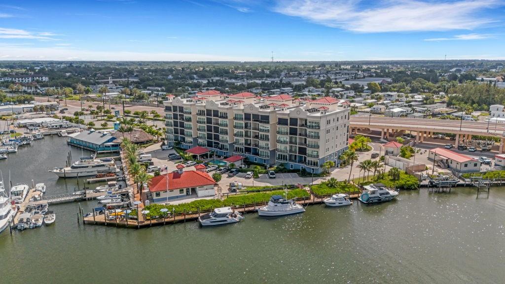 Fully Furnished. Located on the 5th floor of Porto Vista, one of Venice's newest condominium communities, this nearly 2,000 sq. ft. residence offers panoramic views of the Marina, Intracoastal Waterway, and Gulf of Mexico. Rarely used and custom finished throughout, the unit features 3 bedrooms, 2 bathrooms, luxury hardwood floors, 10-foot ceilings, solid wood doors, crown molding, plantation shutters, custom designed closets throughout the entire unit.
The kitchen includes GE stainless steel appliances, quartz countertops, under-cabinet lighting, a custom exhaust hood, Timberlake solid wood cabinetry, an 11-foot peninsula, and a custom tile backsplash. The living and dining areas open to a private balcony with western exposure and water views.
The primary suite features private lanai access, an oversized walk-in closet, and an ensuite bathroom with dual vanities and a custom walk-in Roman shower. Two additional bedrooms provide ample space for guests, a home office, or seasonal living.
The residence includes a private enclosed one-car garage located beneath the building, secure elevator access from garage level, and abundant guest parking.
Porto Vista is a 40-unit waterfront community. The 40 units include 4 ten unit buildings giving the Unit a wall of side windows. Additionally the privacy of only two units on each floor is rare. Amenities include a heated swimming pool, cabana, and poolside gazebo. Its location is one of the community's most desirable features. Residents are within a short walk of Historic Downtown Venice, where you'll find restaurants, shopping, entertainment, community events, and farmers markets. Venice Beach, the Venice Fishing Pier, marinas, golf courses, parks, and the Legacy Trail are all just minutes away.
With waterfront views, custom finishes, a private garage, and a walkable location close to downtown and the beach, this residence offers an opportunity to own in one of Venice's most convenient and sought-after areas. Call and schedule your private showing today!